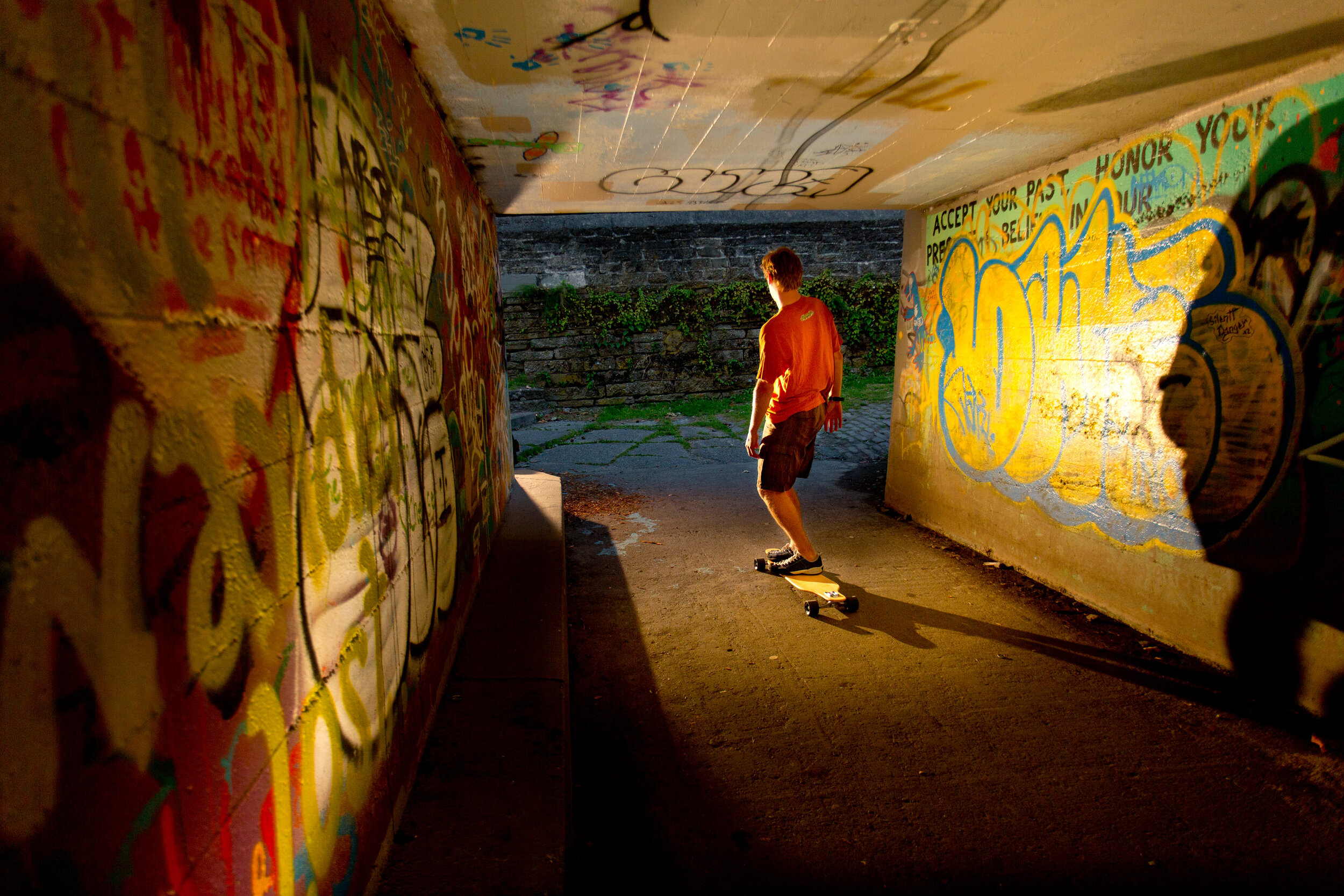  Lifestyle: Chris Solomon riding a longboard skateboard through the tunnel at Golden Gardens, Seattle 