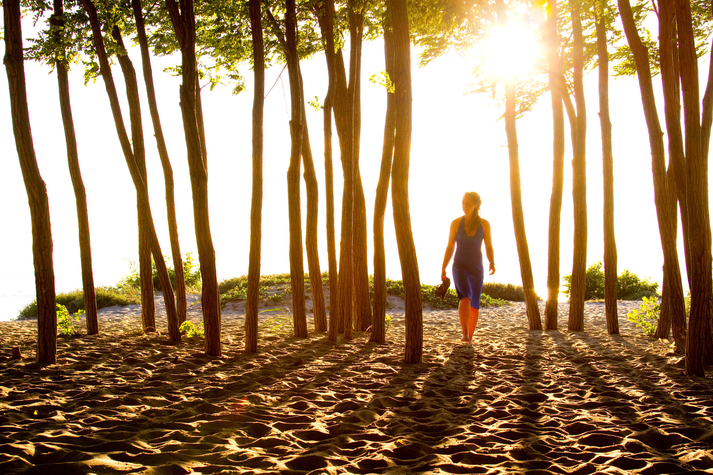  Lifestyle: Kjersti Gedde walking with her cruiser bike through the sand and trees at Golden Gardens Park, Seattle 