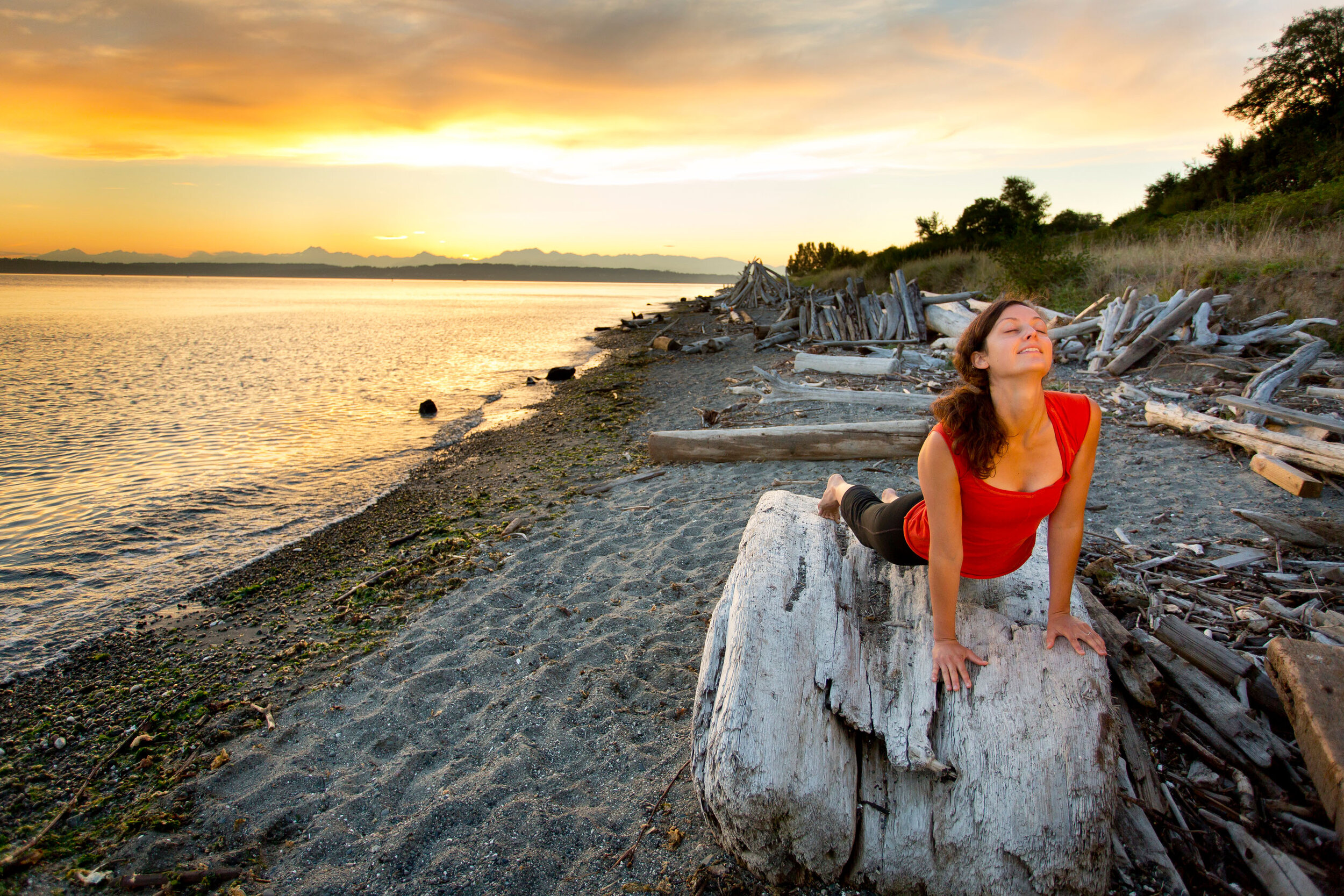  Lifestyle: Elizabeth Kovar doing yoga on the beach at Discovery Park at sunset, Seattle 