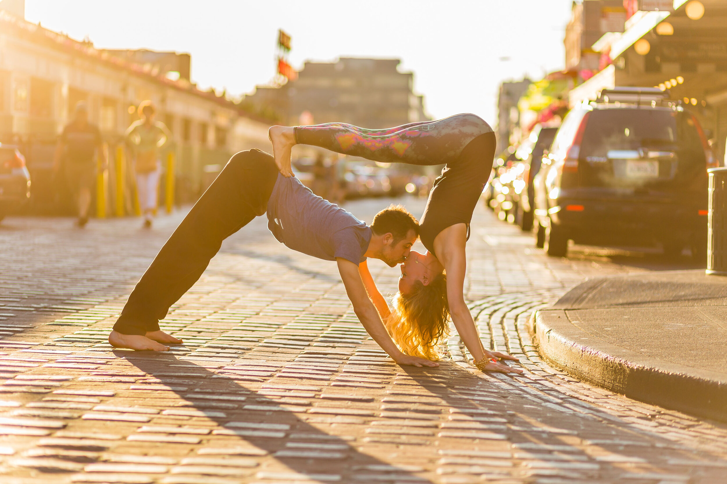  Lifestyle: Noé Khalfa and Karina Brossman practicing partners yoga at Pike Place Market in late summer light, Seattle, Washington 