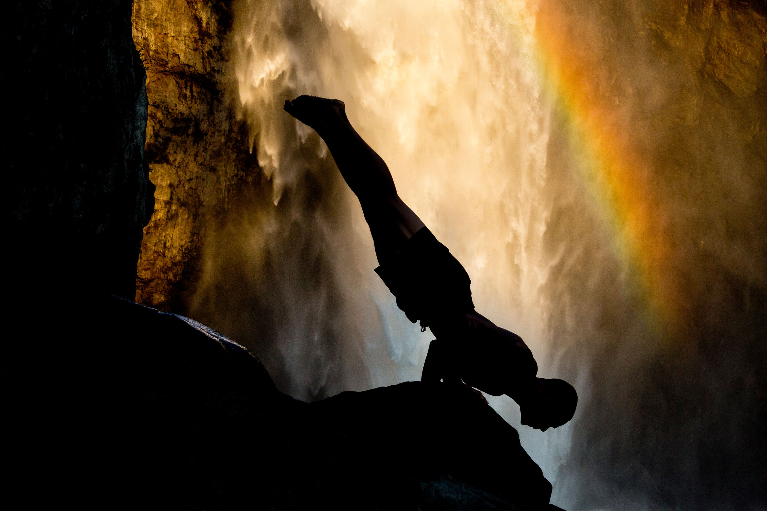  Lifestyle: Gabriel Juzon practicing yoga below Snoqualmie Falls, Central Cascade Mountains, Washington 