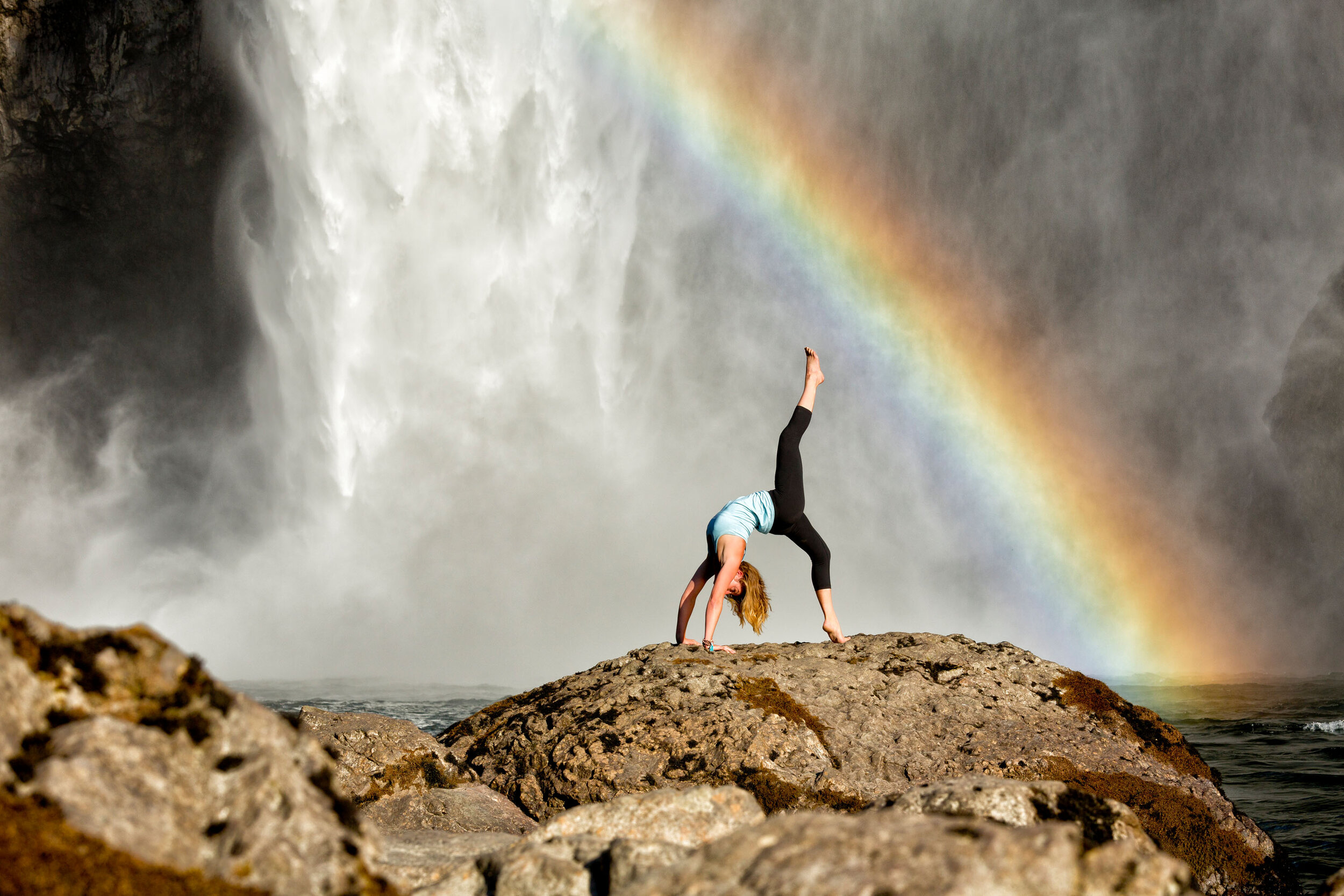  Lifestyle: Kristen Shaw practicing yoga below Snoqualmie Falls, Central Cascade Mountains, Washington 
