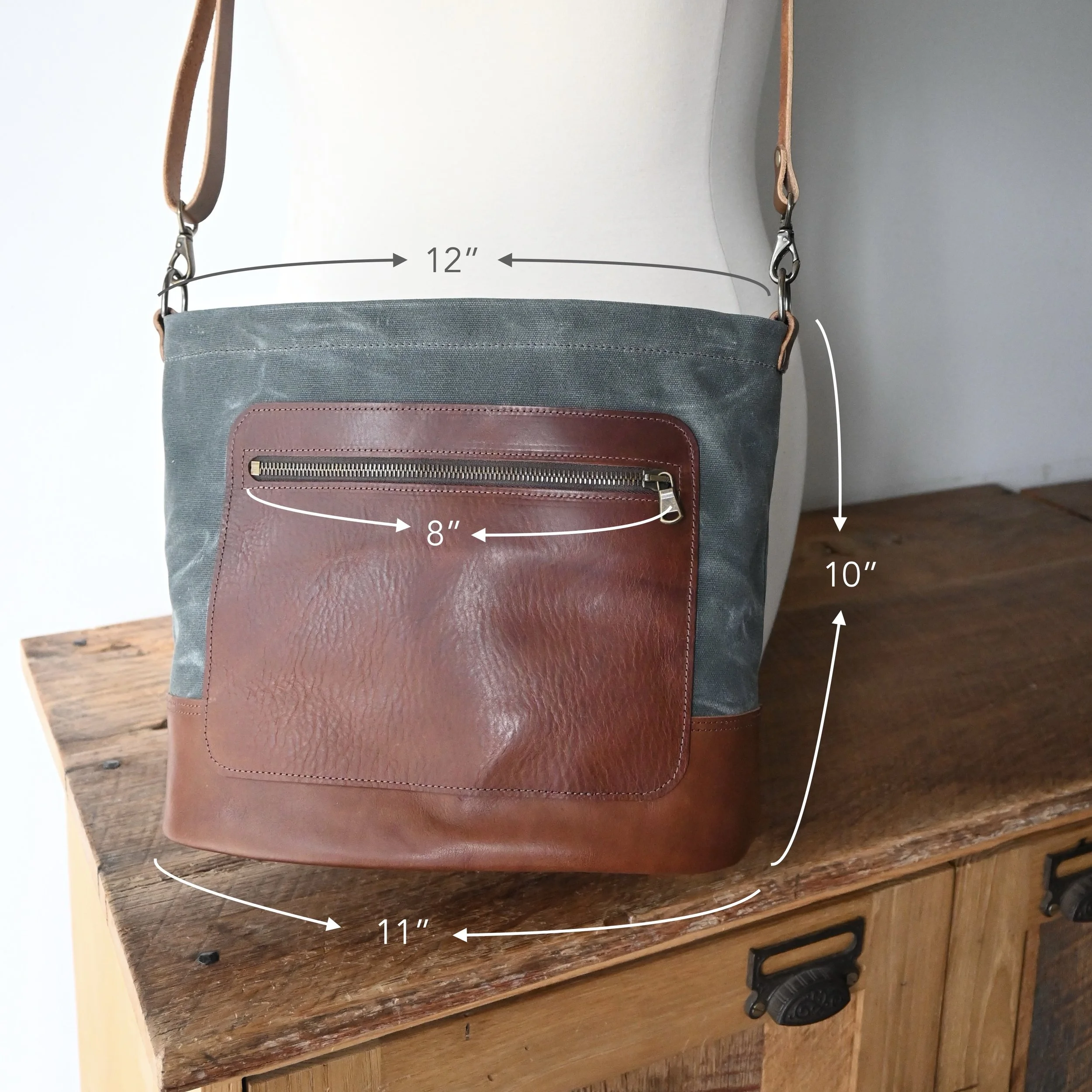 Waxed canvas and leather Day Bag with measurements. The bag is about 10" tall, by 12" wide at the top, and about 11" wide at the bottom.