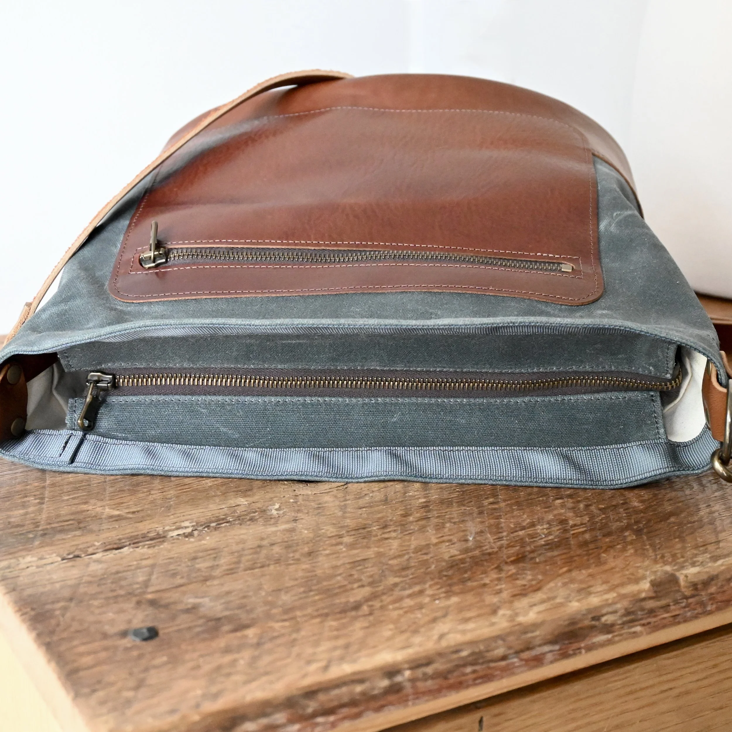 Waxed Canvas and leather Day Bag with zipper top. The zipper is on a placket allowing the bag to fully open more like a tote bag than a handbag.