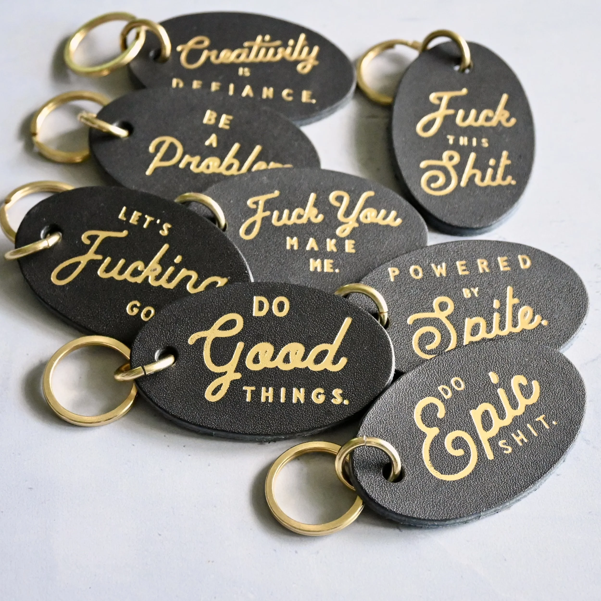 Stitch & Rivet swearing leather keychains ovals .JPG