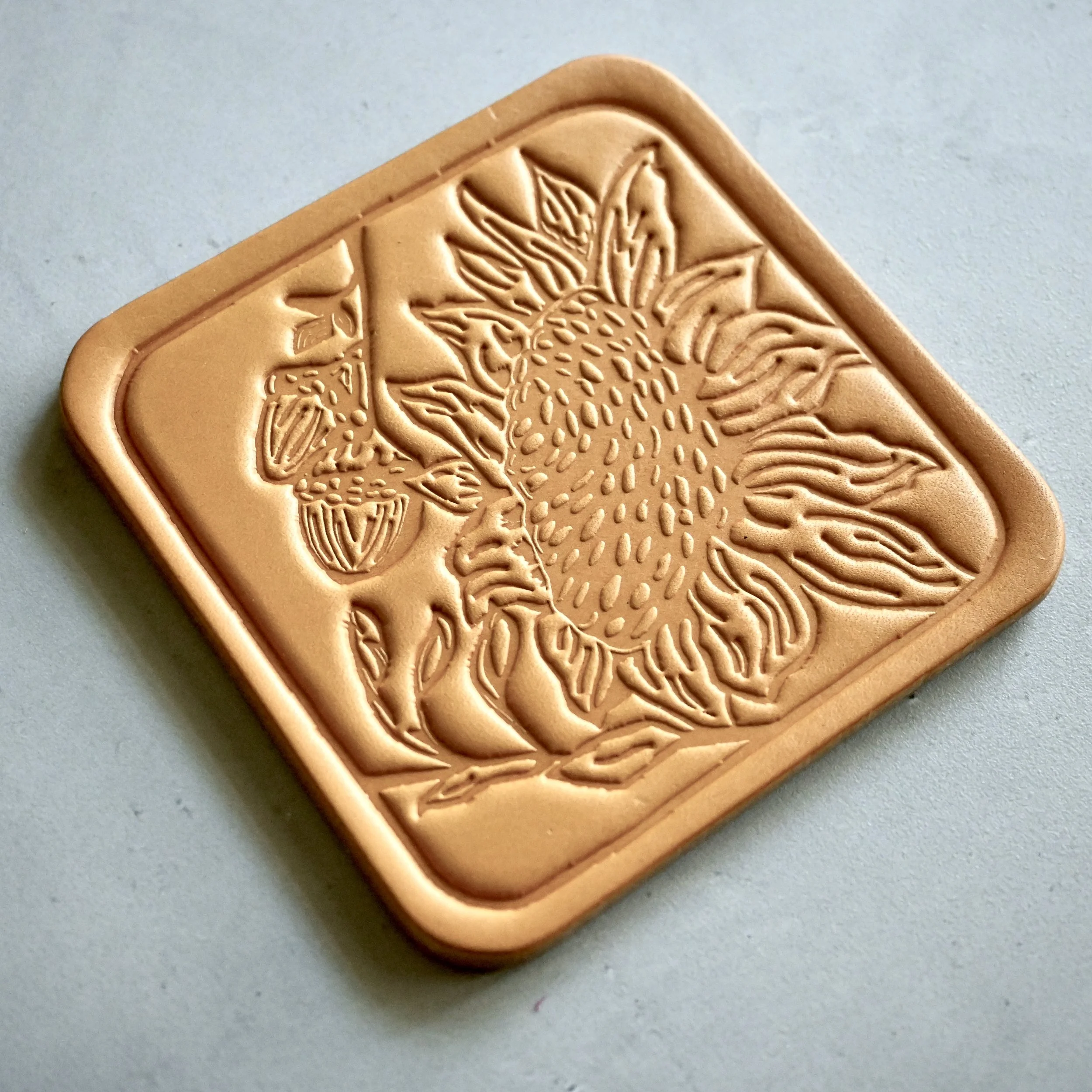 Leather Coaster with sunflowers and acorns.JPG