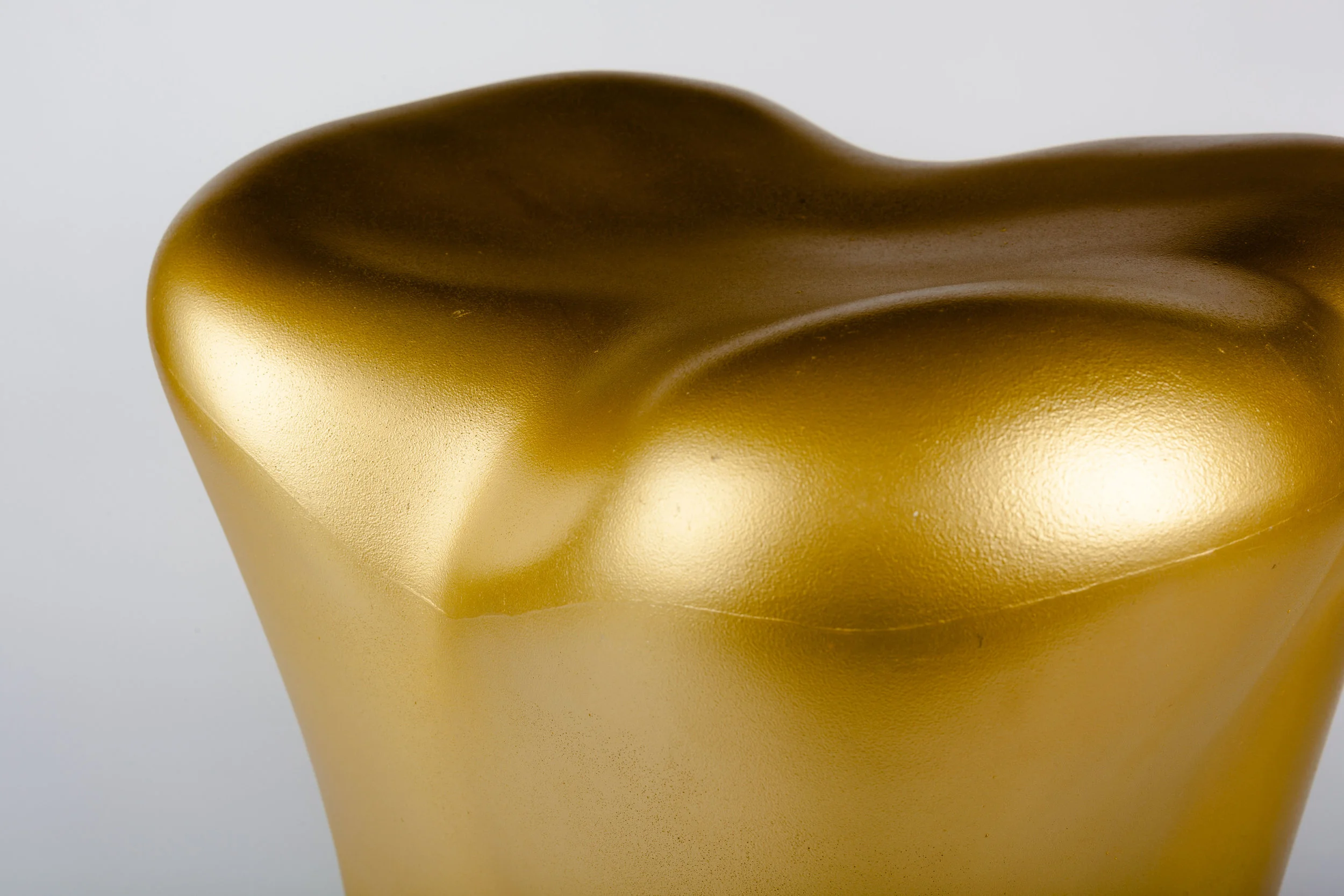 Starck Stool in a shape of a gold tooth