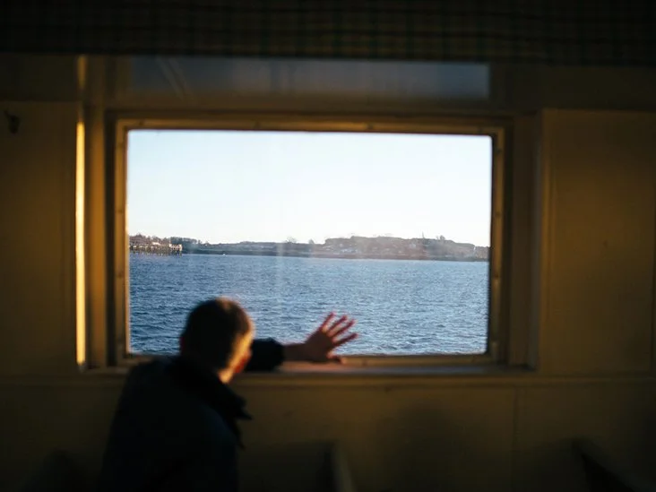 blurred-rear-view-man-looking-out-window-ferry-boat-water-732x549-thumbnail.jpg