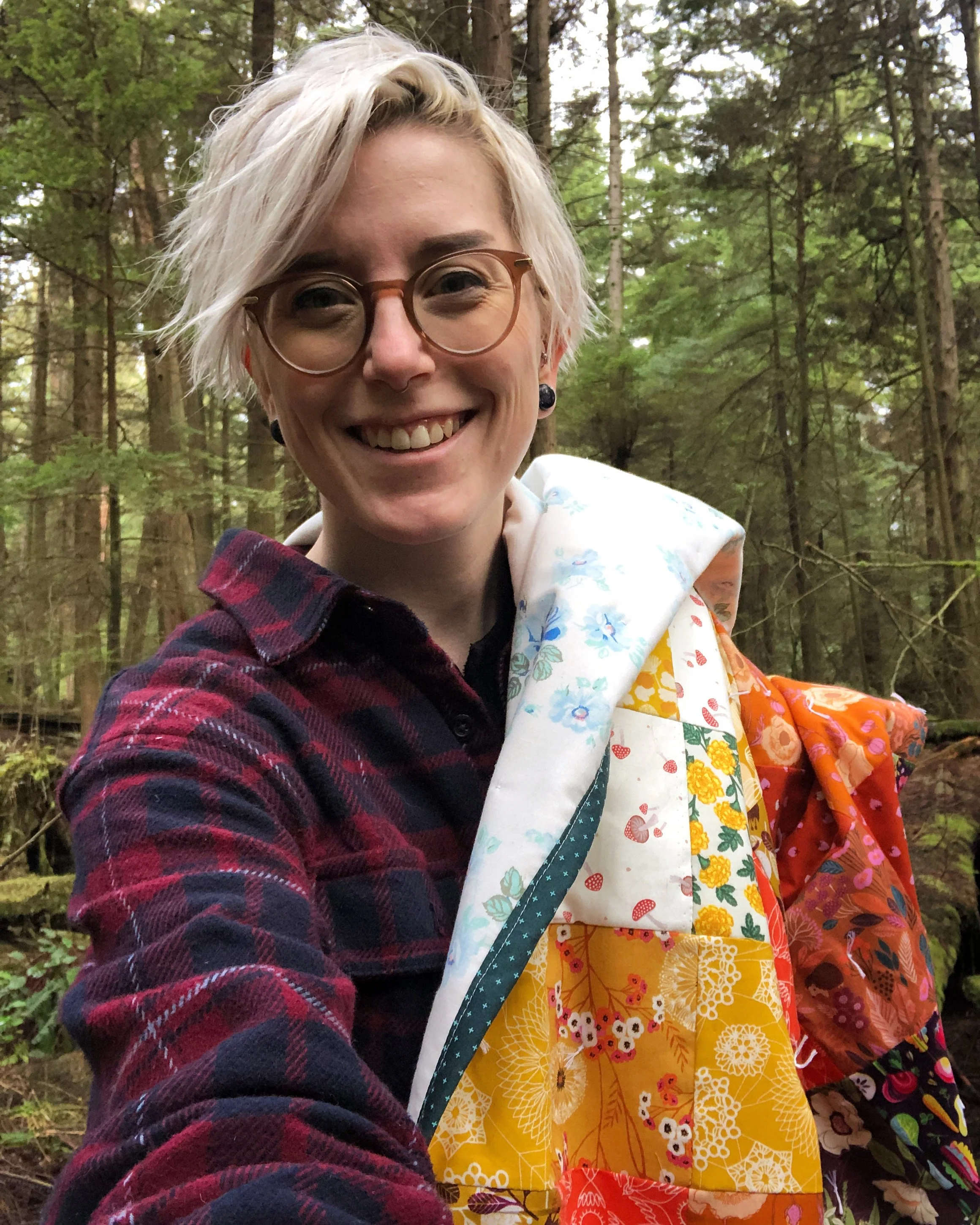 smiling at the camera with a quilt over my shoulder