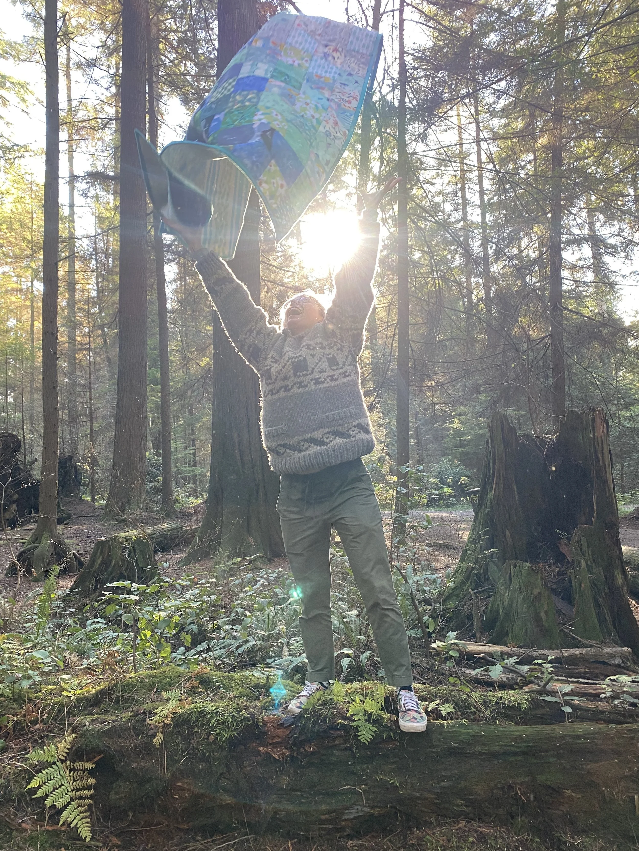 doing a quilt toss photo in the forest