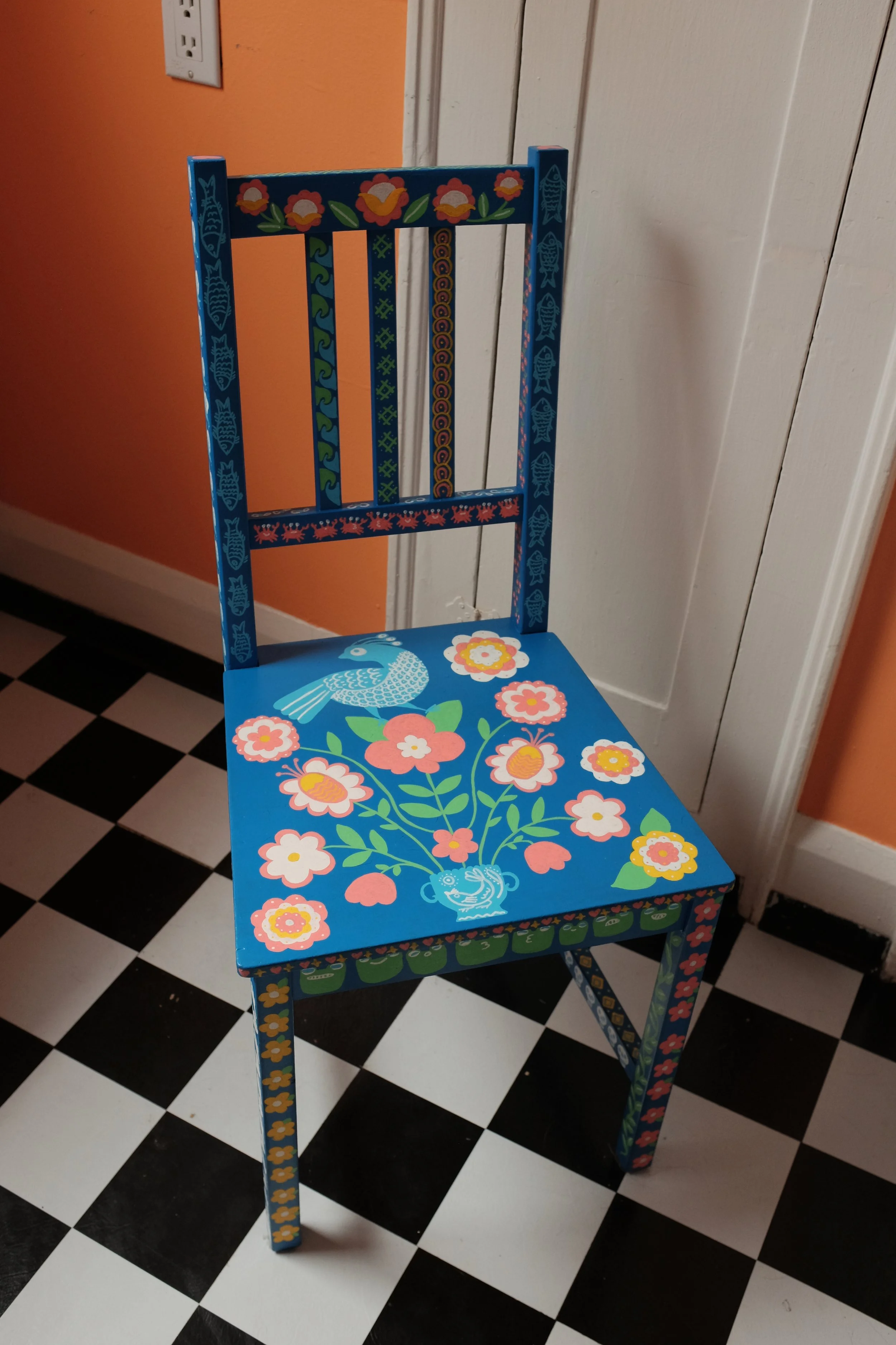 a blue chair with brighty coloured designs