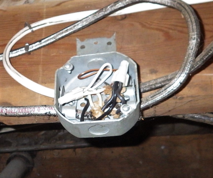 New wiring spliced onto the existing cloth-wrapped wiring.