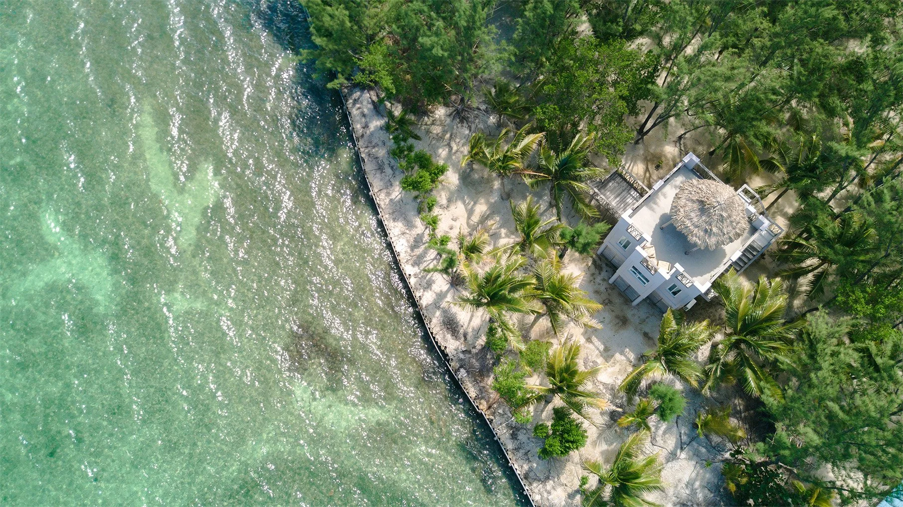 Oceanfront cabanas on private island Thatch Caye Belize.jpg