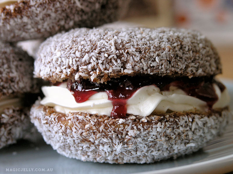 Baked lamington donuts filled with cherry jam and cashew cream . Donut recipe here .