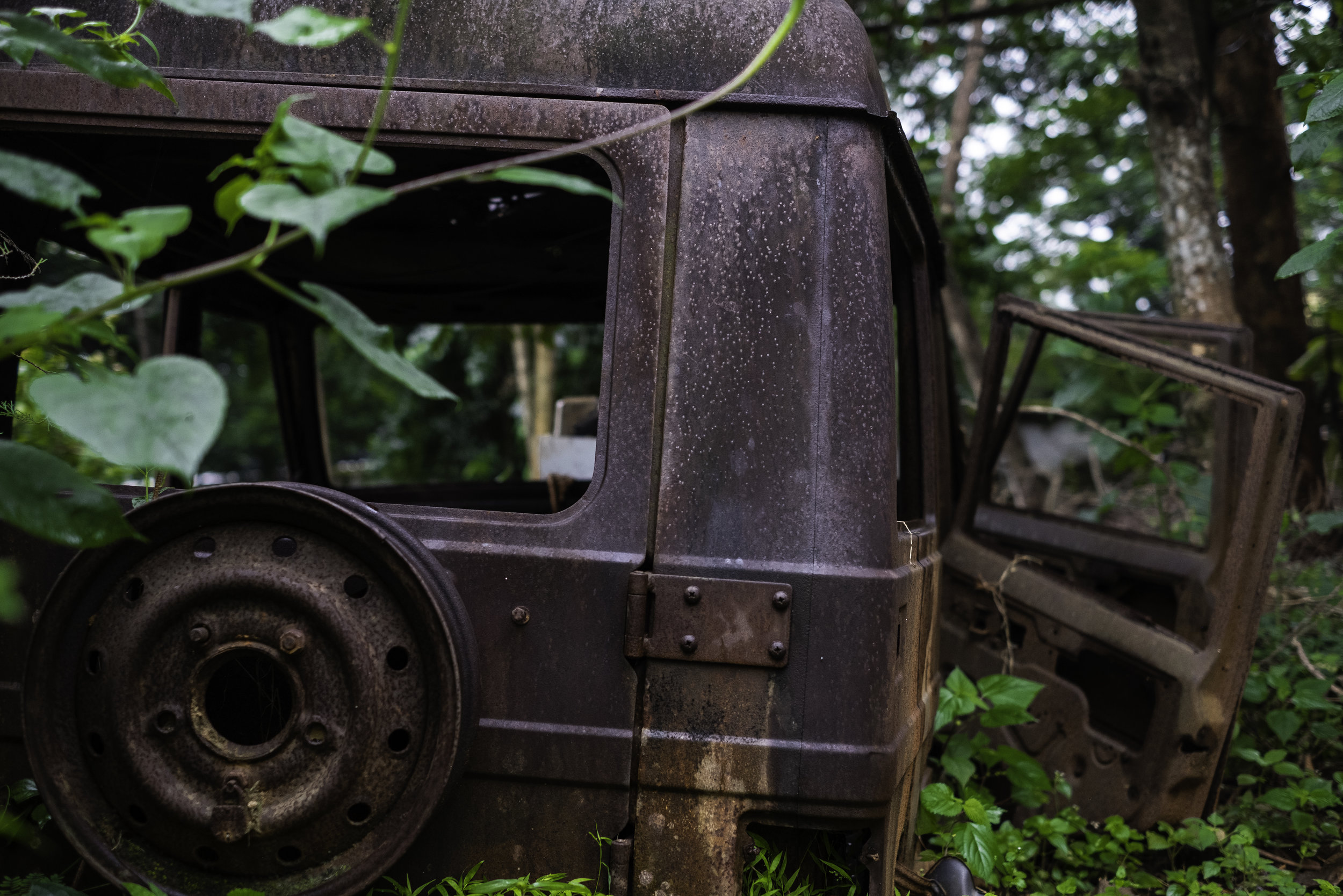   A destroyed jeep still sits where it was last parked in the courtyard of a Catholic compound in Kandhamal, India. During the Summer of 2008, and violent mob of Hindu nationalists forcibly entered the property where they proceeded to rape the nuns a