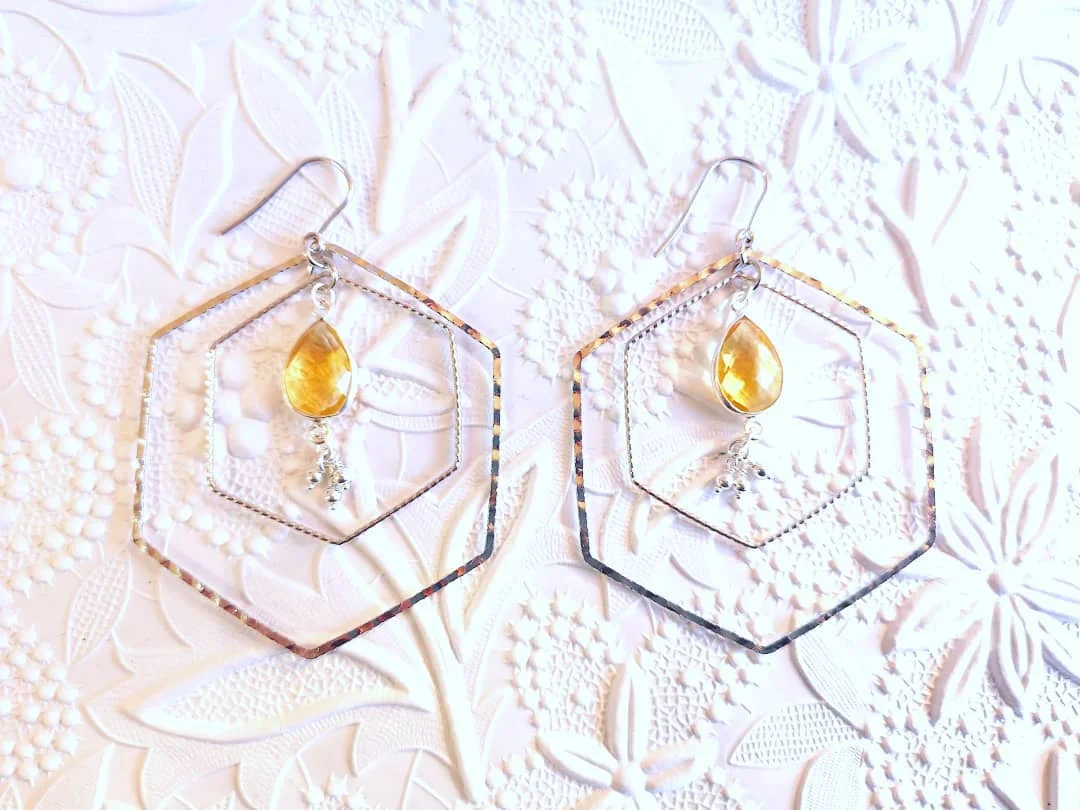Did you know all our jewellery with a bee themed motif goes directly into the proceeds of keeping our bees healthy and happy? Sterling silver and citrine drop hexagon earrings.