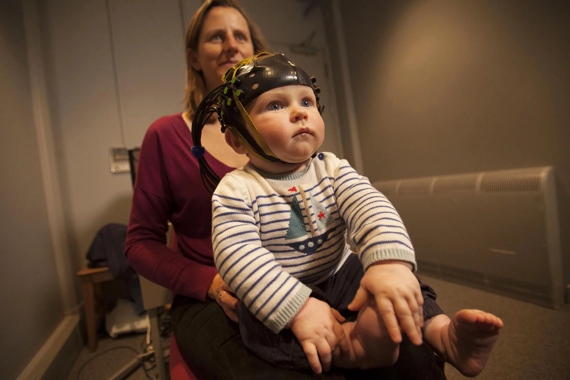 Mother and baby at the Babylab research facility for UV brain scan test at University College London Medical Physics Department in London. For the Bill & Melinda Gates Foundation.