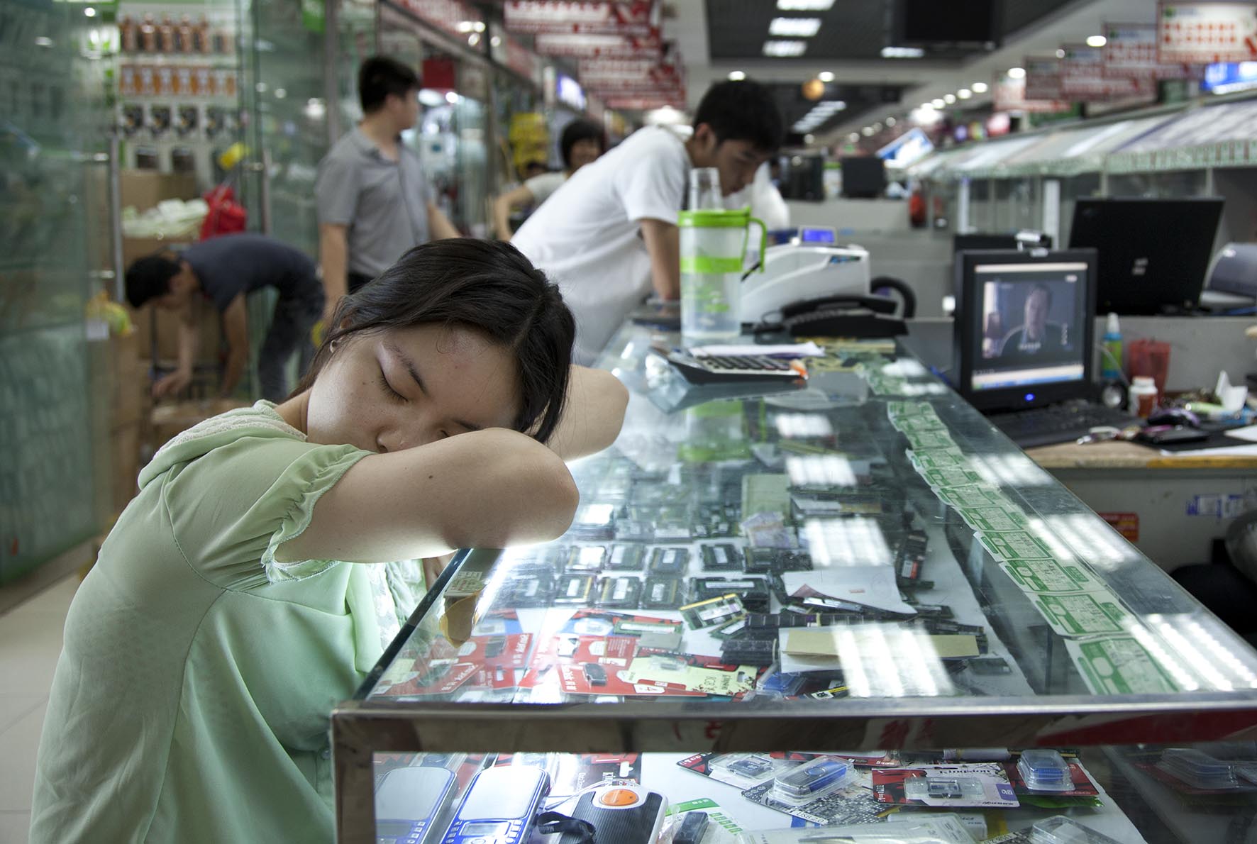  Computer seller asleep inside e-plaza digital square shopping mall Zhongguancun. 