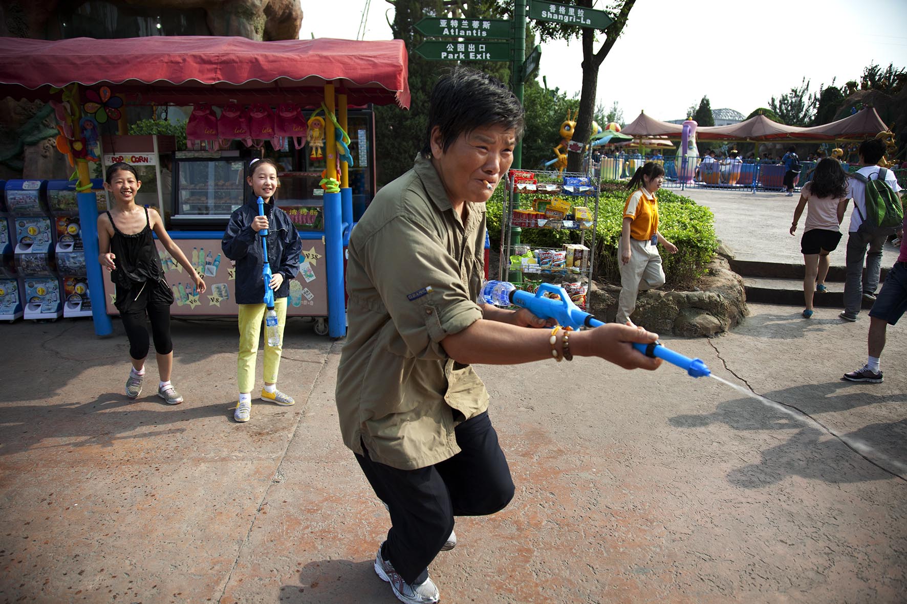  One parent joins in a water pistol fight at Happy Valley amusement park. 