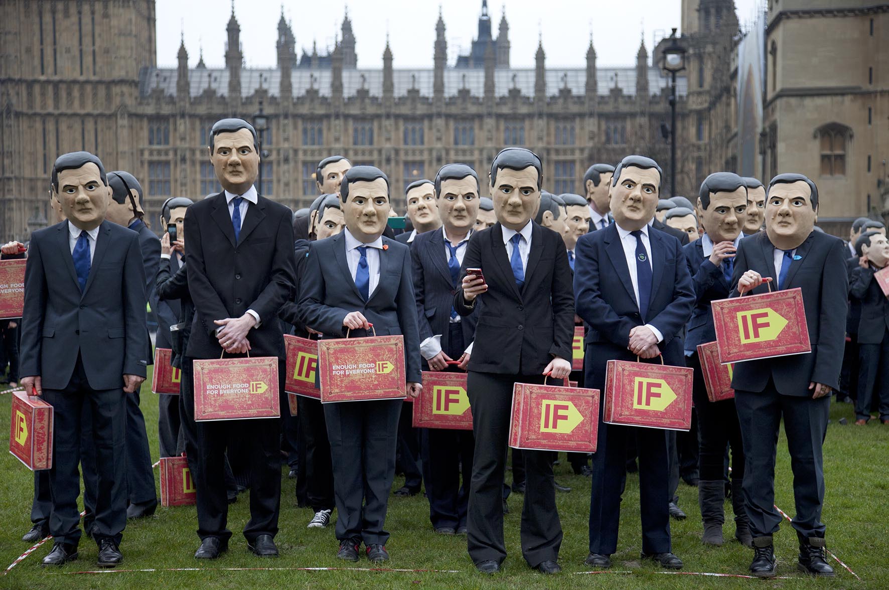  IF Campaign activists dressed as George Osborne gather in Westminster to remind the Chancellor to uphold aid promises and end tax dodging. 