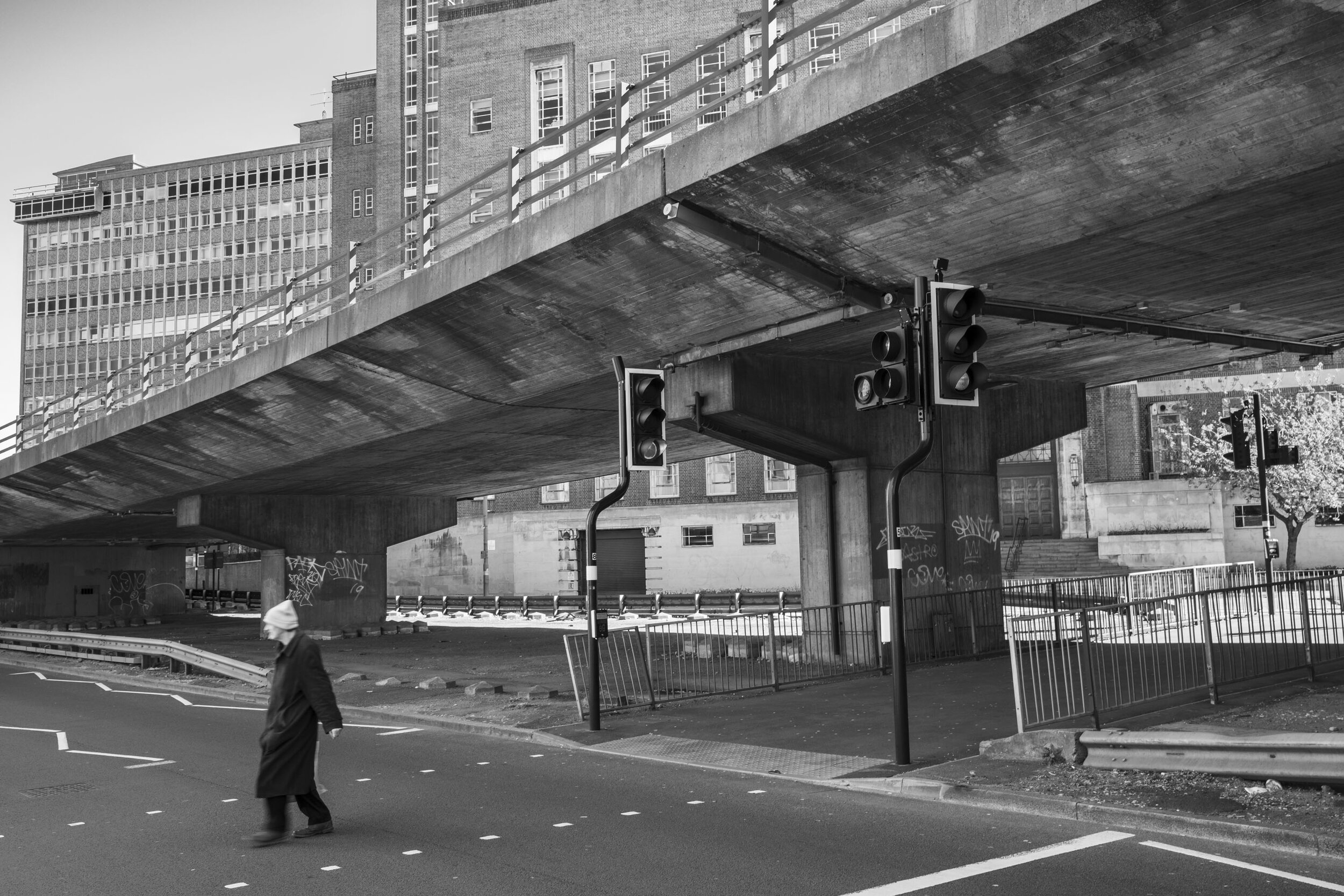  Some life continues on the street as Aston Expressway, where the A38 soars above, is quiet overhead, on what is normally one of the busiest roads in Birmingham. April 2020. City Centre. 