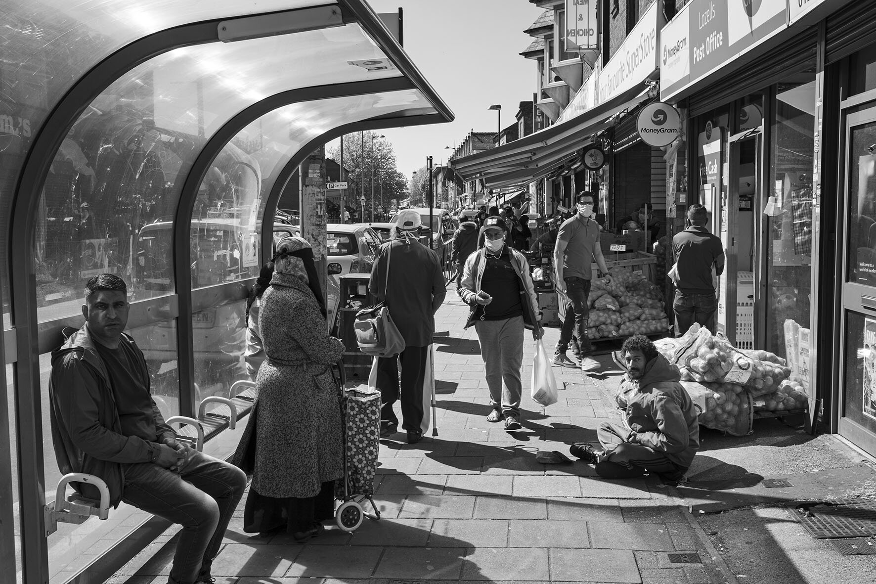  Street scene as food markets trade, while life goes on beside a bus stop. May 2020. Lozells. 