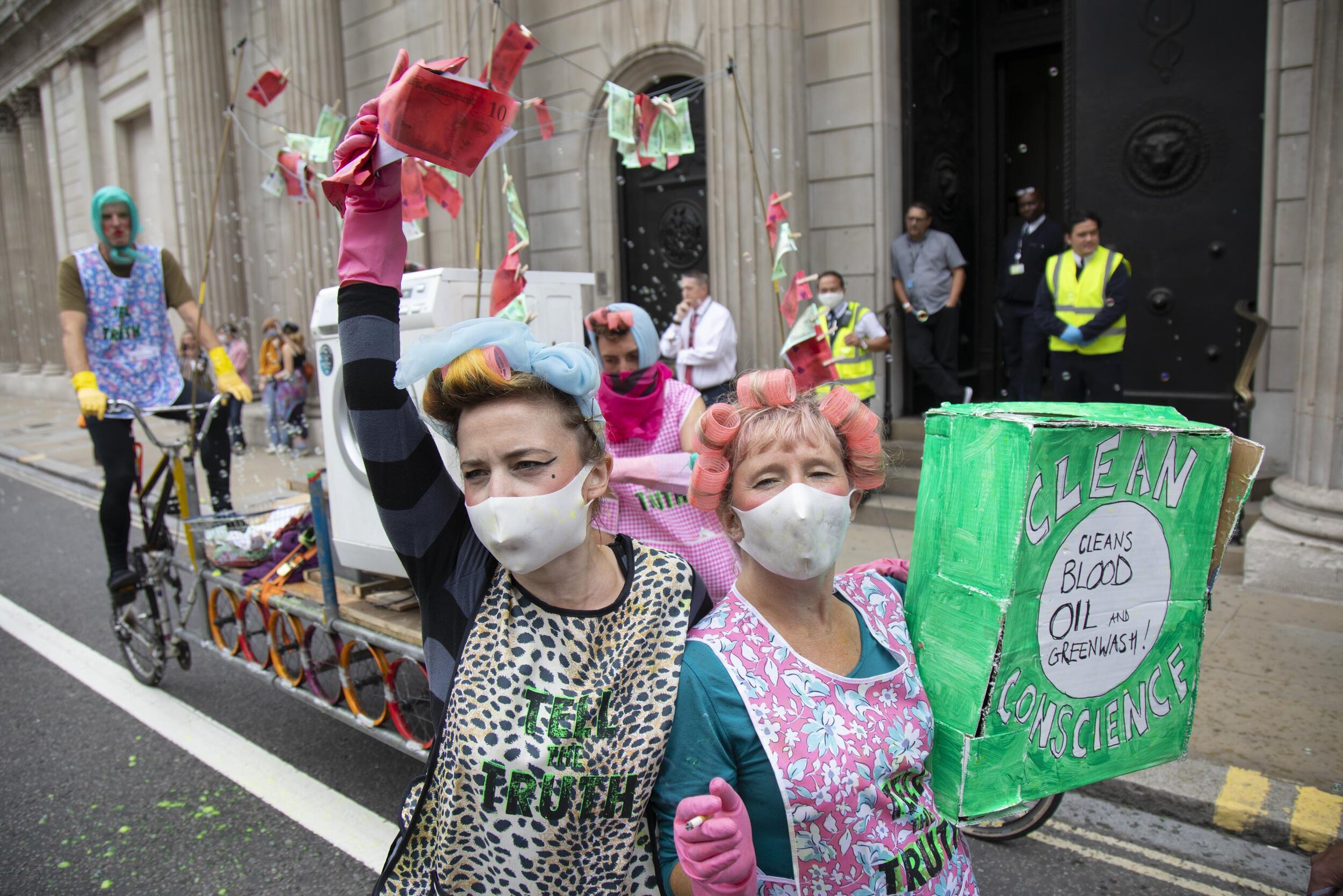  ‘Dirty Scrubbers’ old fashioned washer-women launder the ‘dirty money’ and greenwash stains outside the Bank of England in a performance designed to highlight the corruption of big business and banking. 