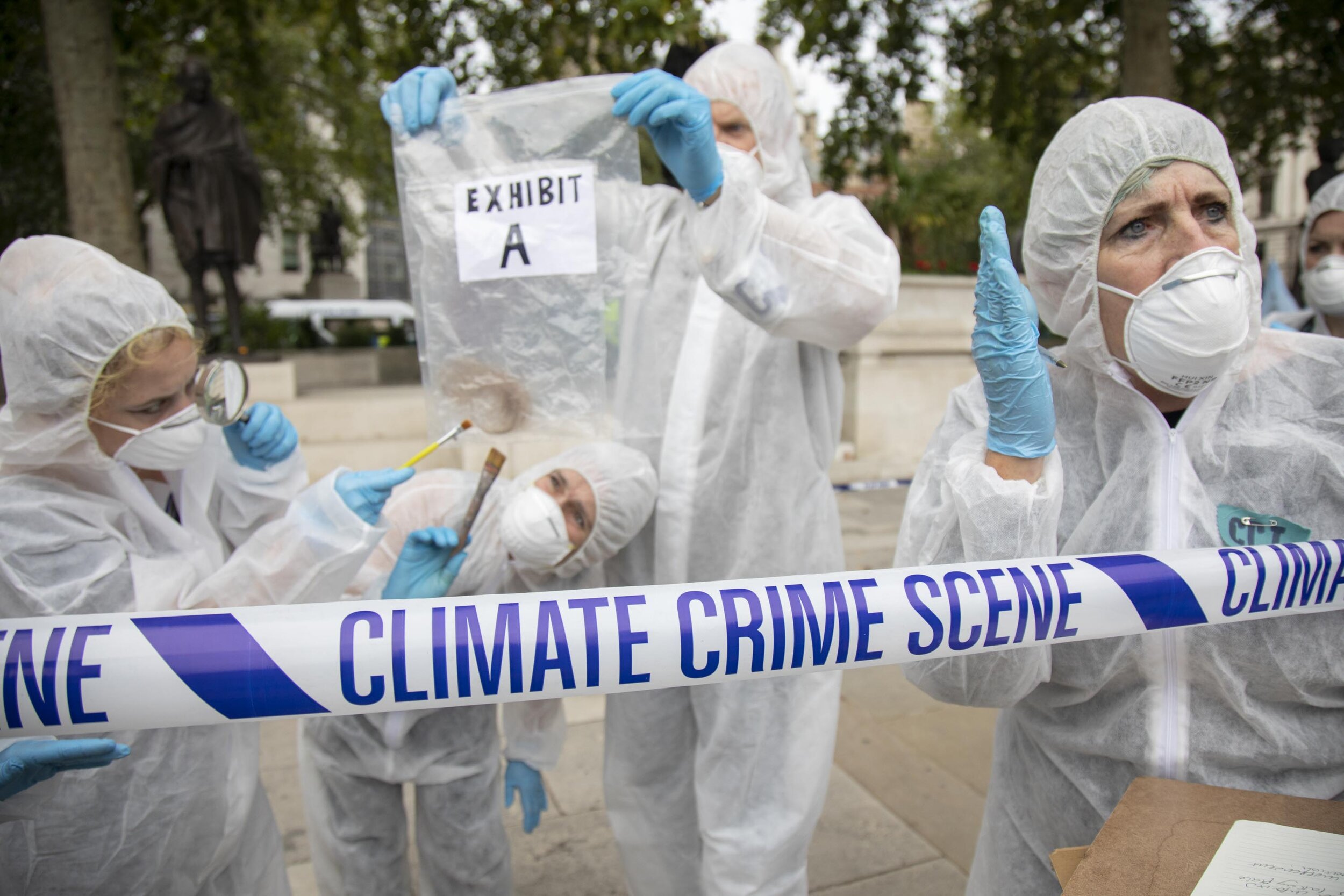  ‘Crime scene investigators’ put up climate crime scene tape to investigate areas of ecocide in a performance protesting at the UK government’s ecocide along the HS2 route. 