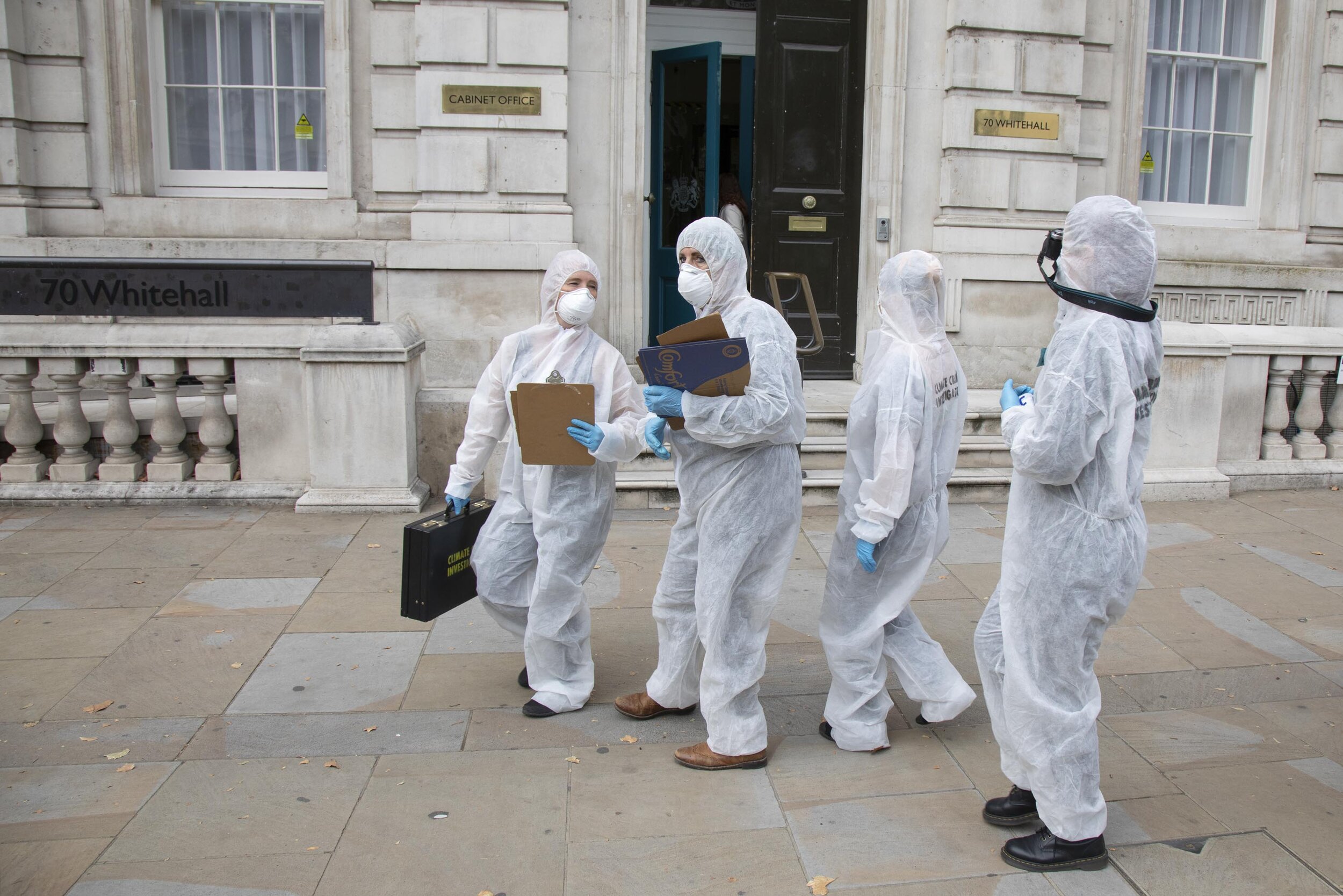  ‘Crime scene investigators’ arrive outside the Cabinet Office in a performance protesting at the UK government’s ecocide along the HS2 route. 