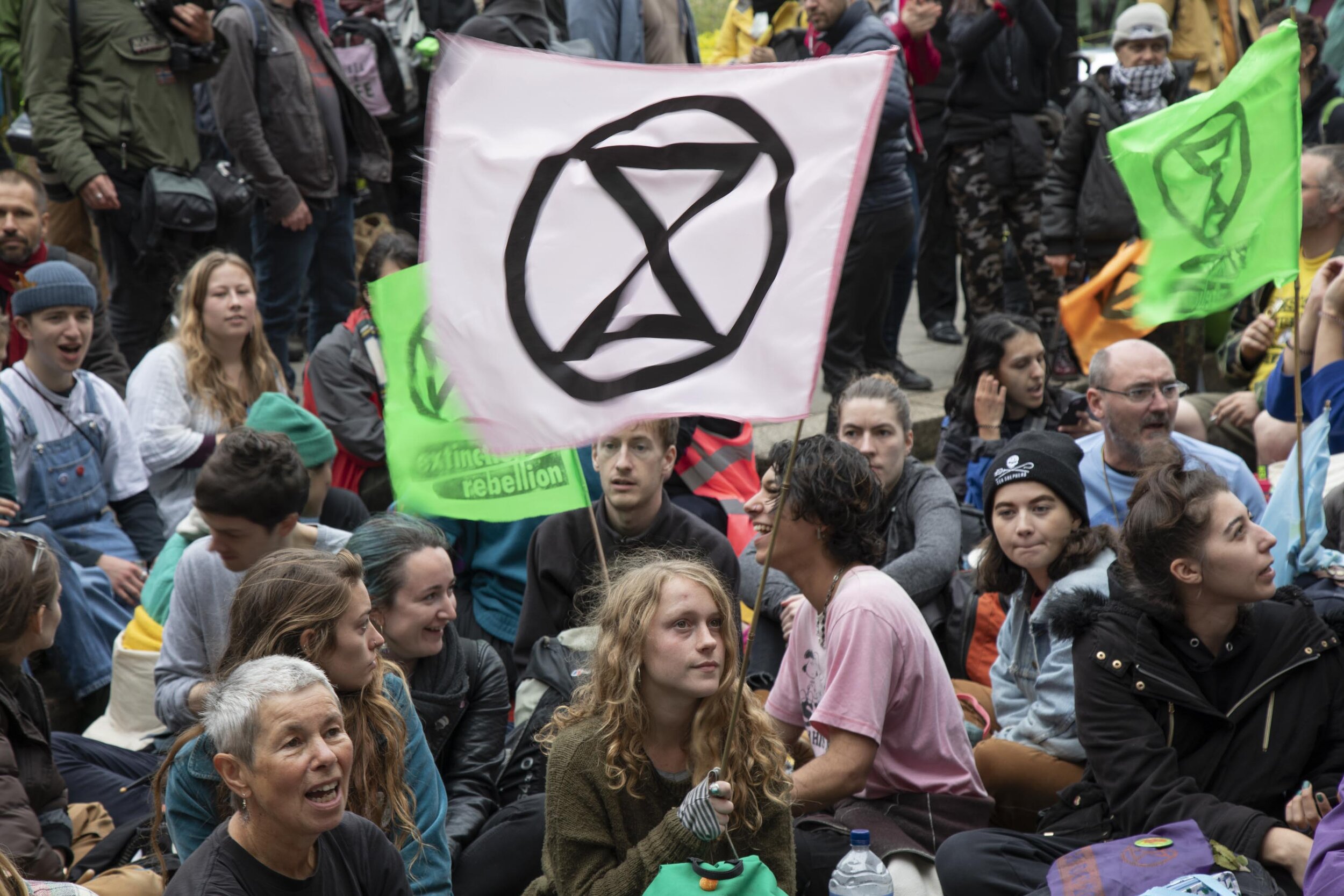  Climate change activists sit down in the road singing songs as sites around Westminster are blocked. 