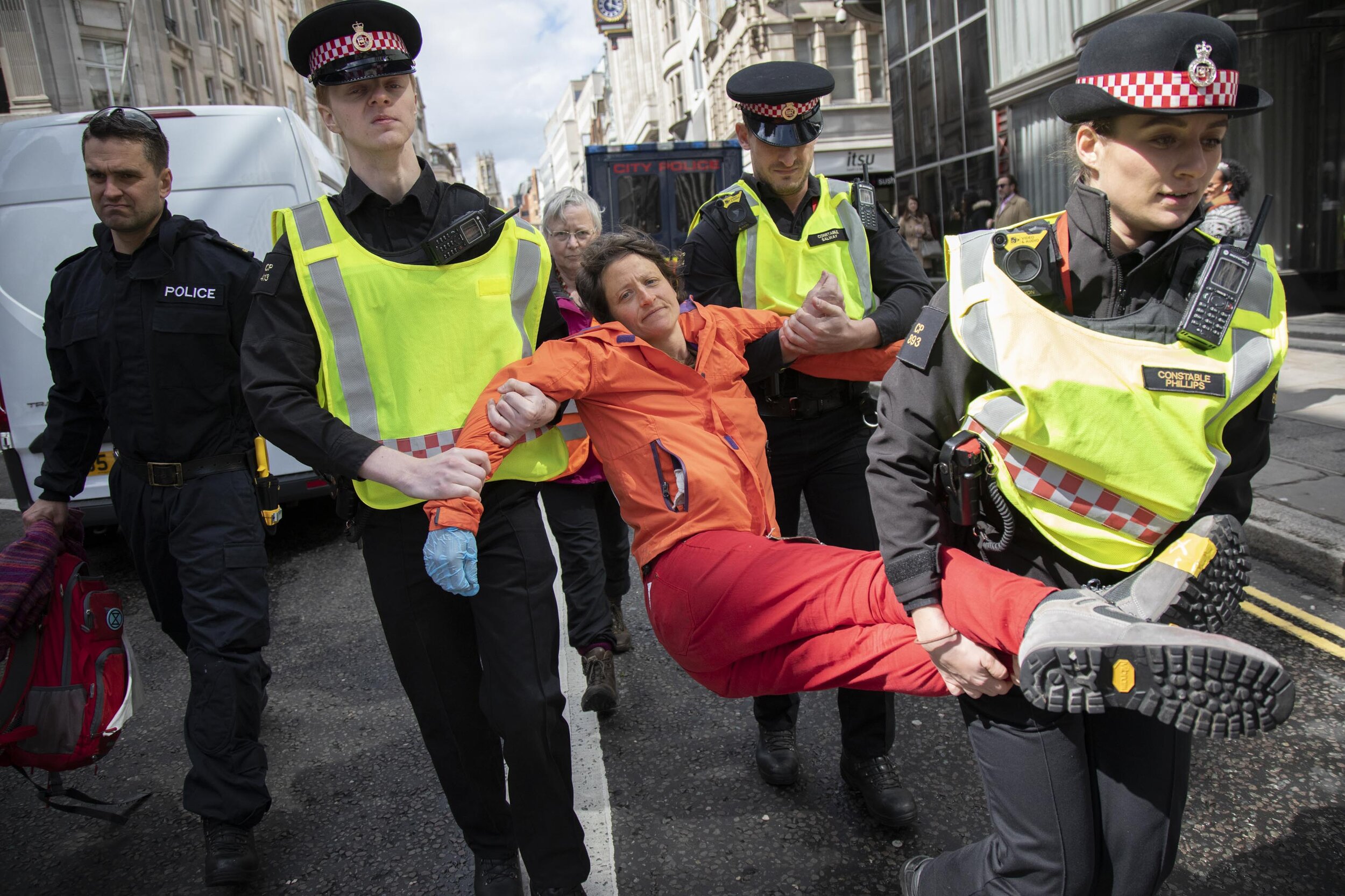  Climate change activist is arrested after being locked on and glued together outside Goldman Sachs International on Fleet Street in the heart of the City of London financial district. 