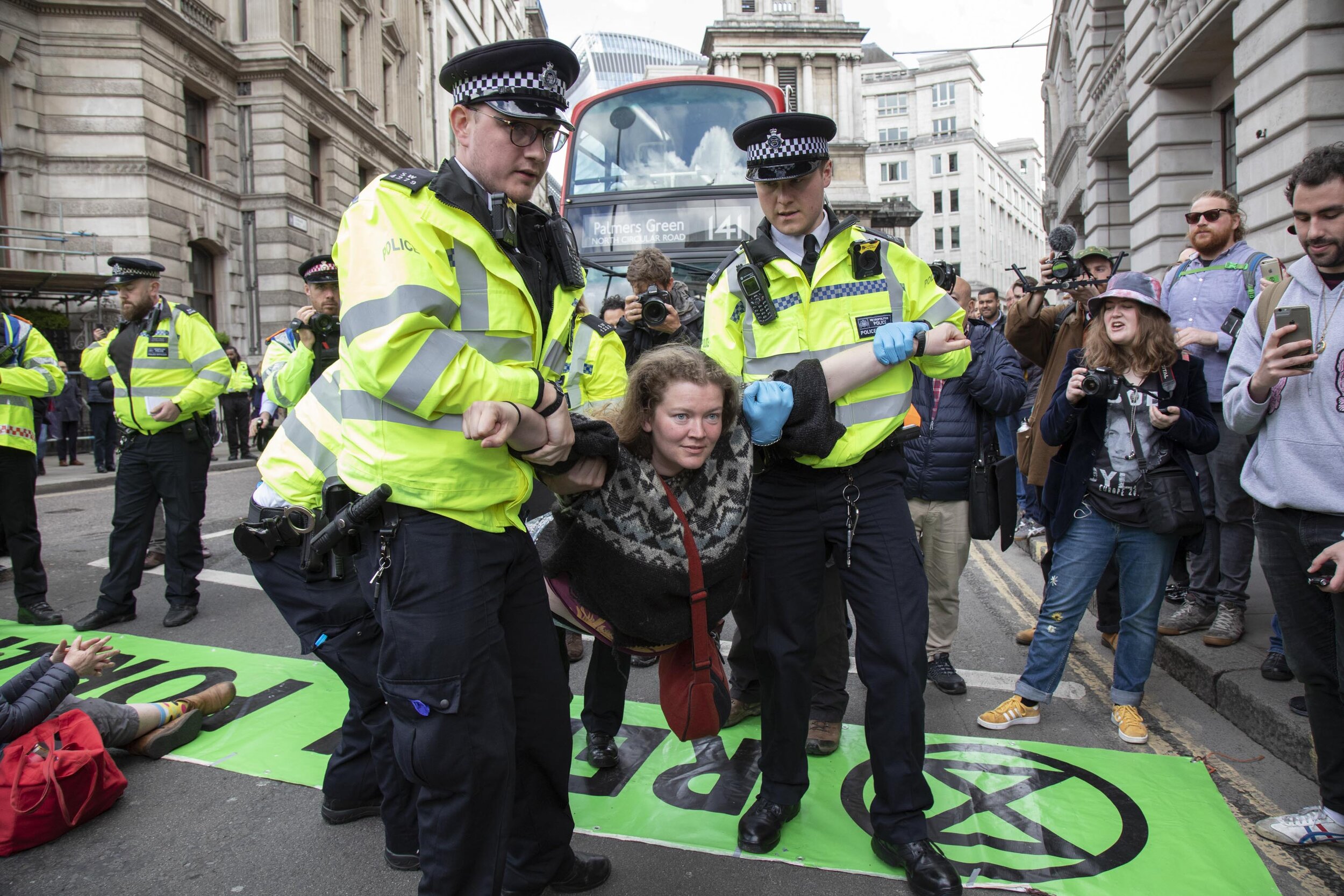  Activist is arrested for blocking the street at Bank in the heart of the City of London in protest that the government is not doing enough to avoid catastrophic climate change. 