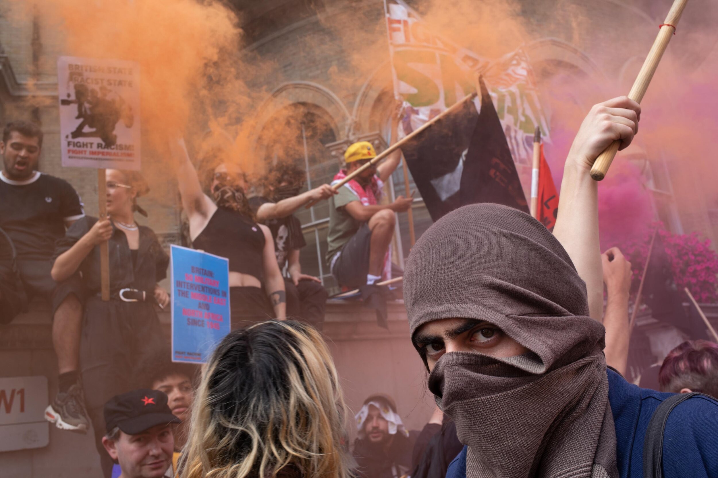  Demonstrators amid smoke flares to oppose the Free Tommy Robinson demonstration, organised by anti-fascist groups including Stand up to Racism. 