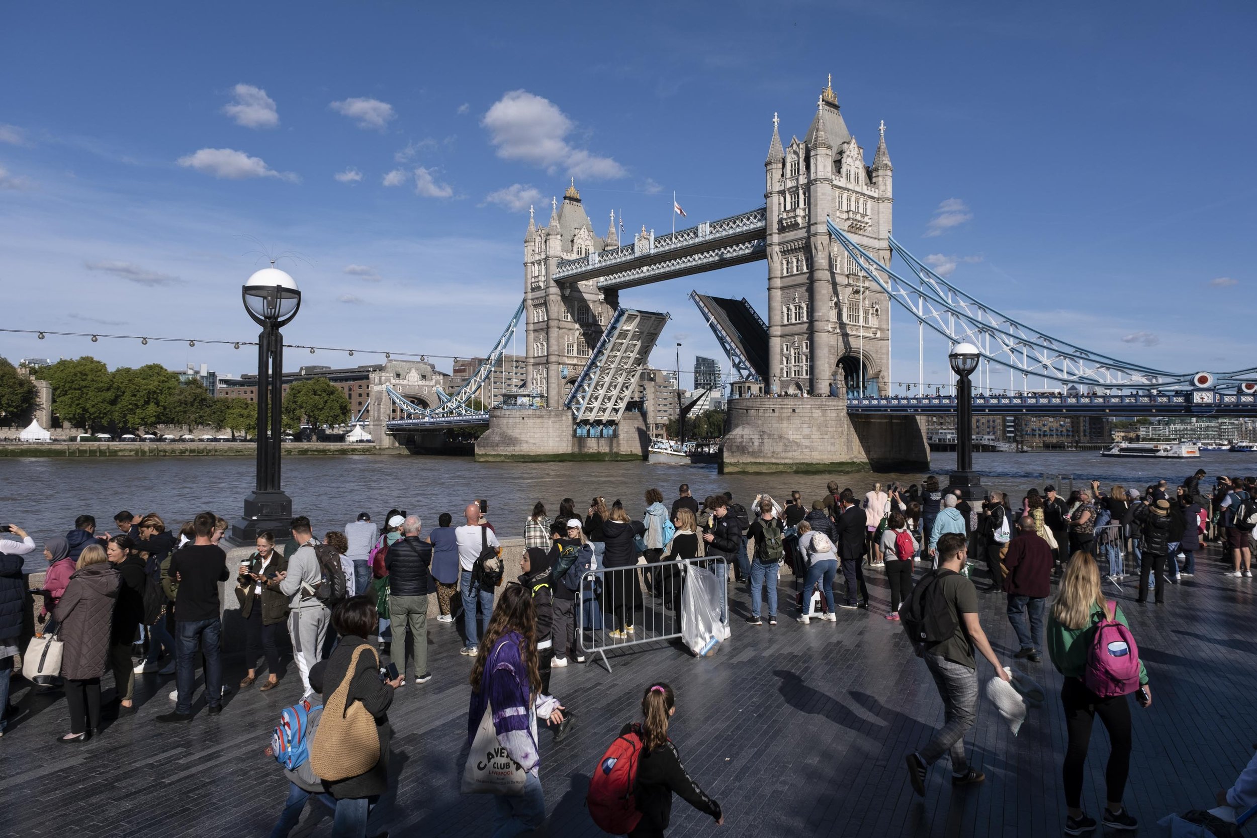  The queue to see Queen lying in state as Tower Bridge opens for a passing barge. 