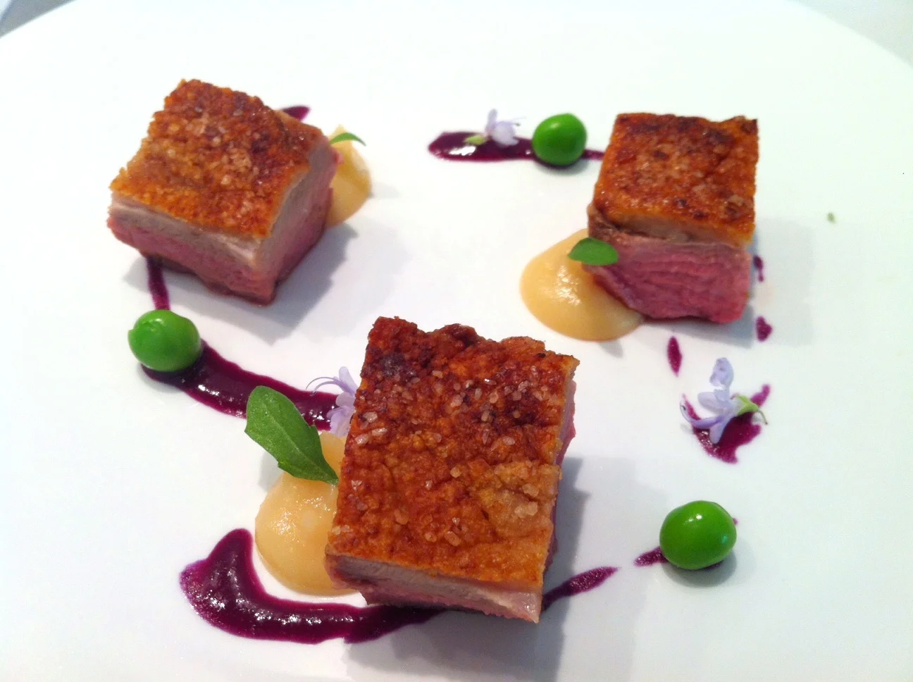 Seared Duck with Quince, English Peas, and "Braised" Red Cabbage