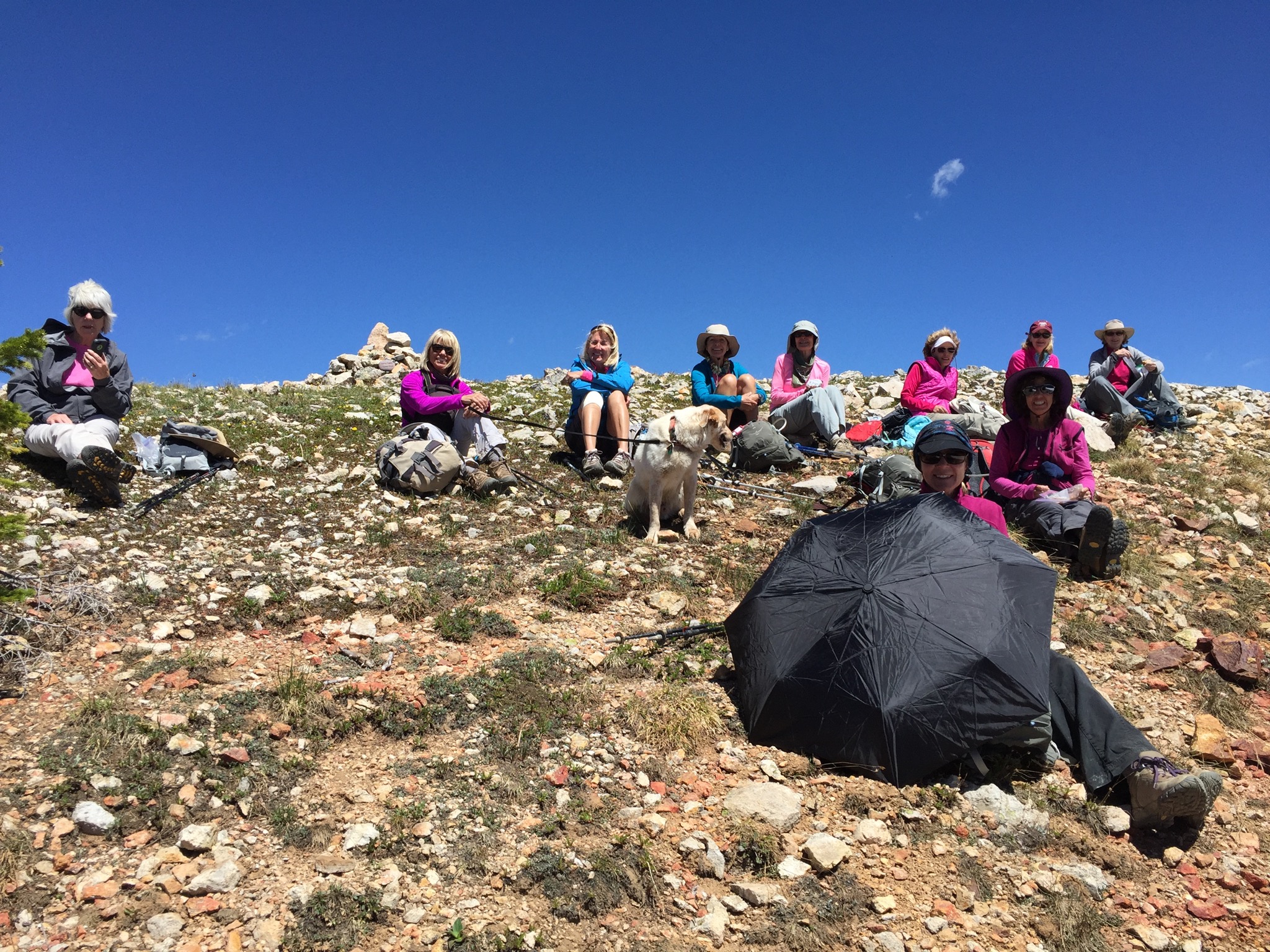 Lunch stop at the summit. Jane Marie shelters Bella from the sun with her umbrella (Photo by Gina Kaufman)