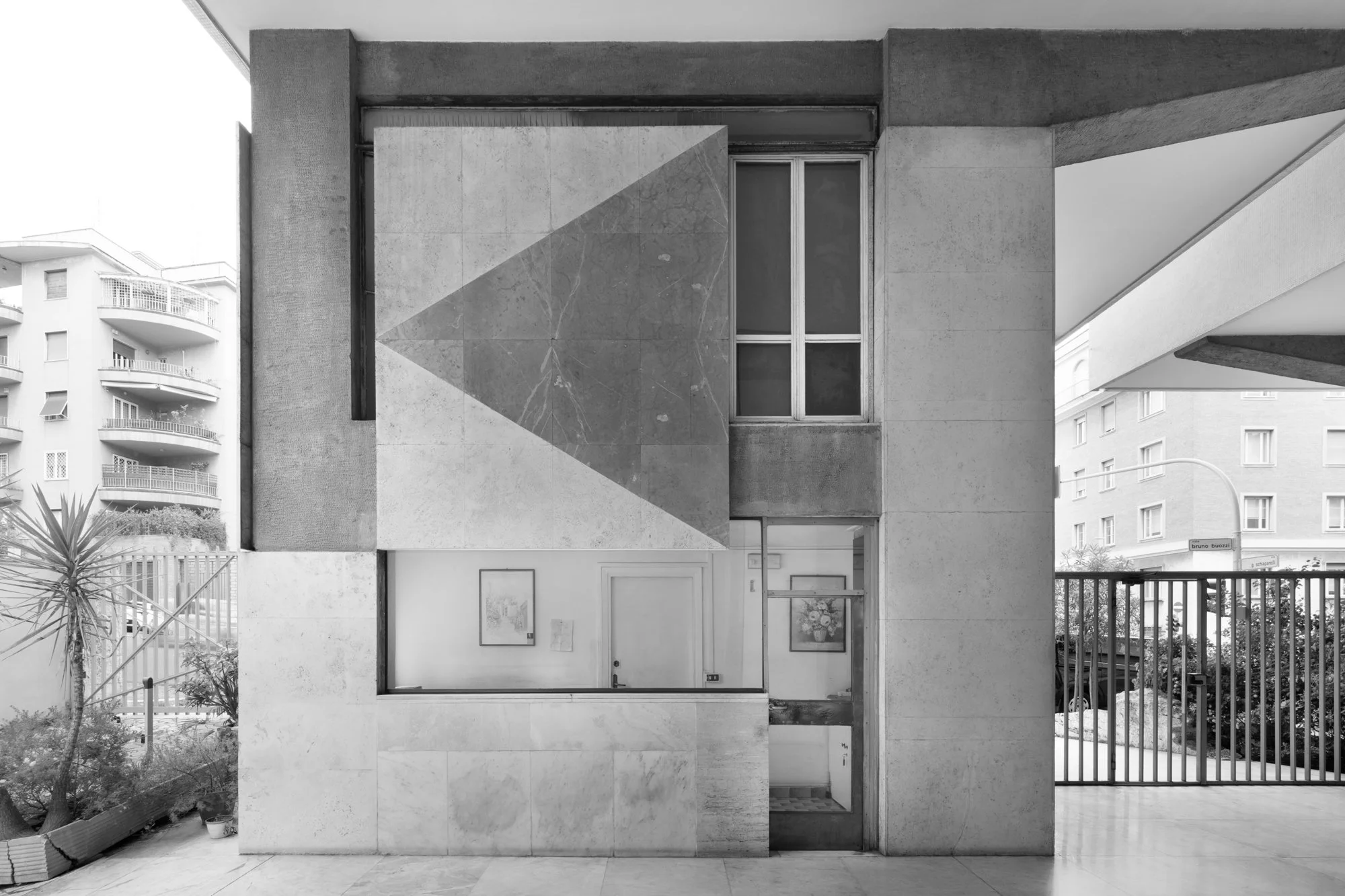       Portinerie Romane*   Spacious windows, antiquated desks, compact passageways—architectures conceived as vitrines framing the threshold between public and private space.   Portinerie Romane  explores this overlooked element of Roman architecture