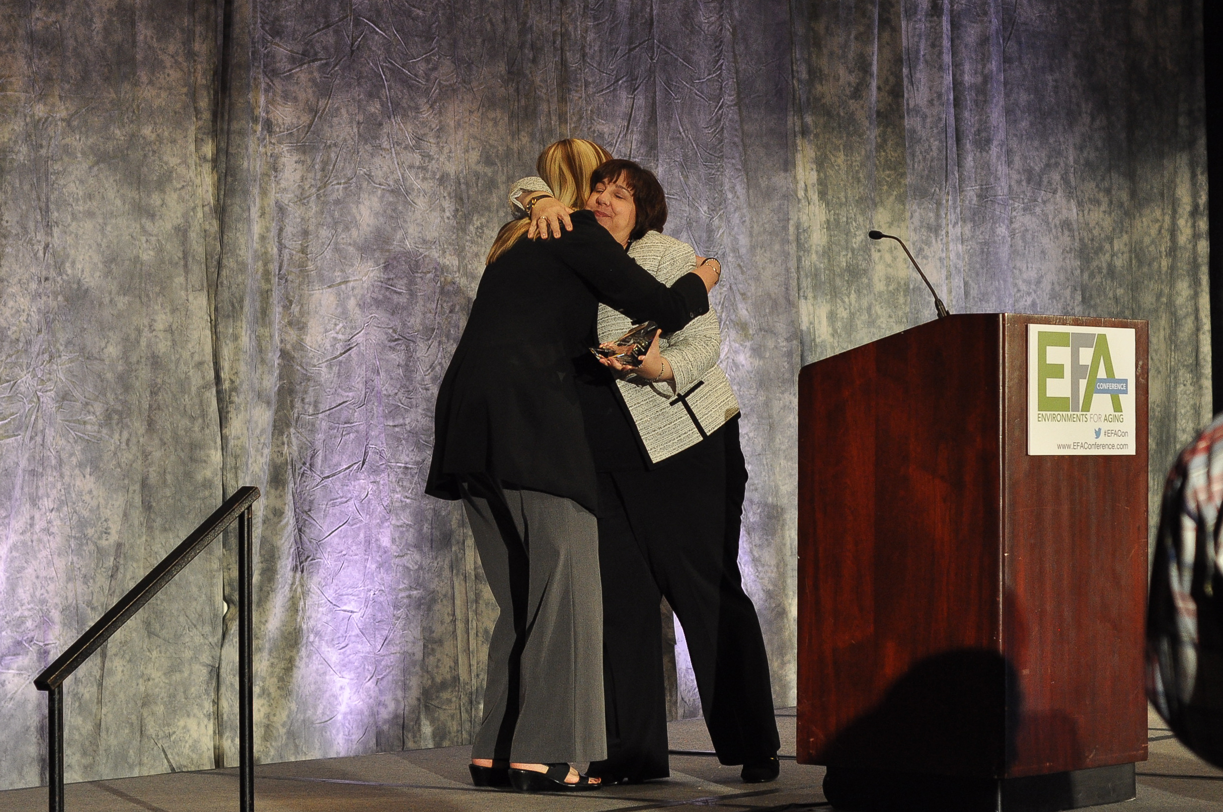 Jane Rohde accepting The Center For Health Design's Changemaker Award at the Environments for Aging Conference from President and CEO of The CHD, Debra Levin