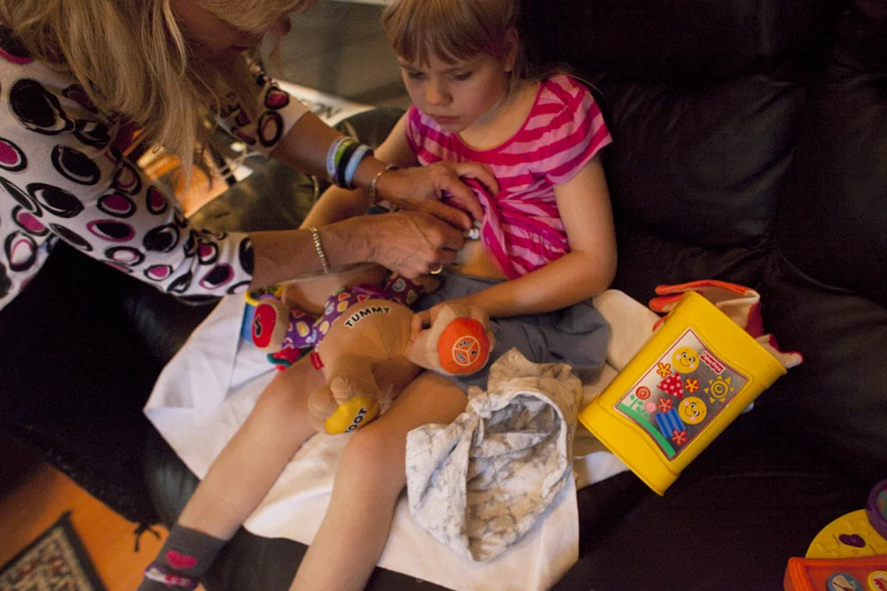 Anneliese attaches CHristina's feeding tube. Jacksonville, FL.