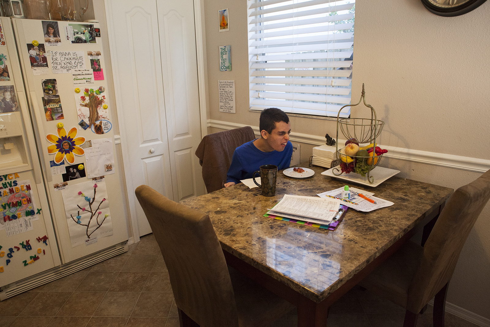 Branden experiencing a short outburst while sitting at the table. Tampa, FL.