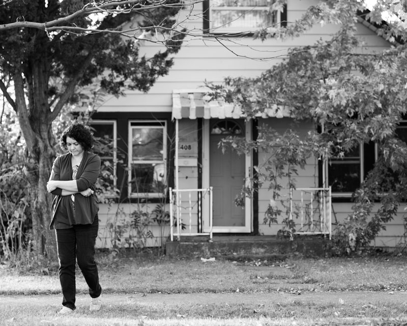  Cindy, his daughter and primary caregiver, walks away from her dilapidated childhood home in Northlake, Illinois. 