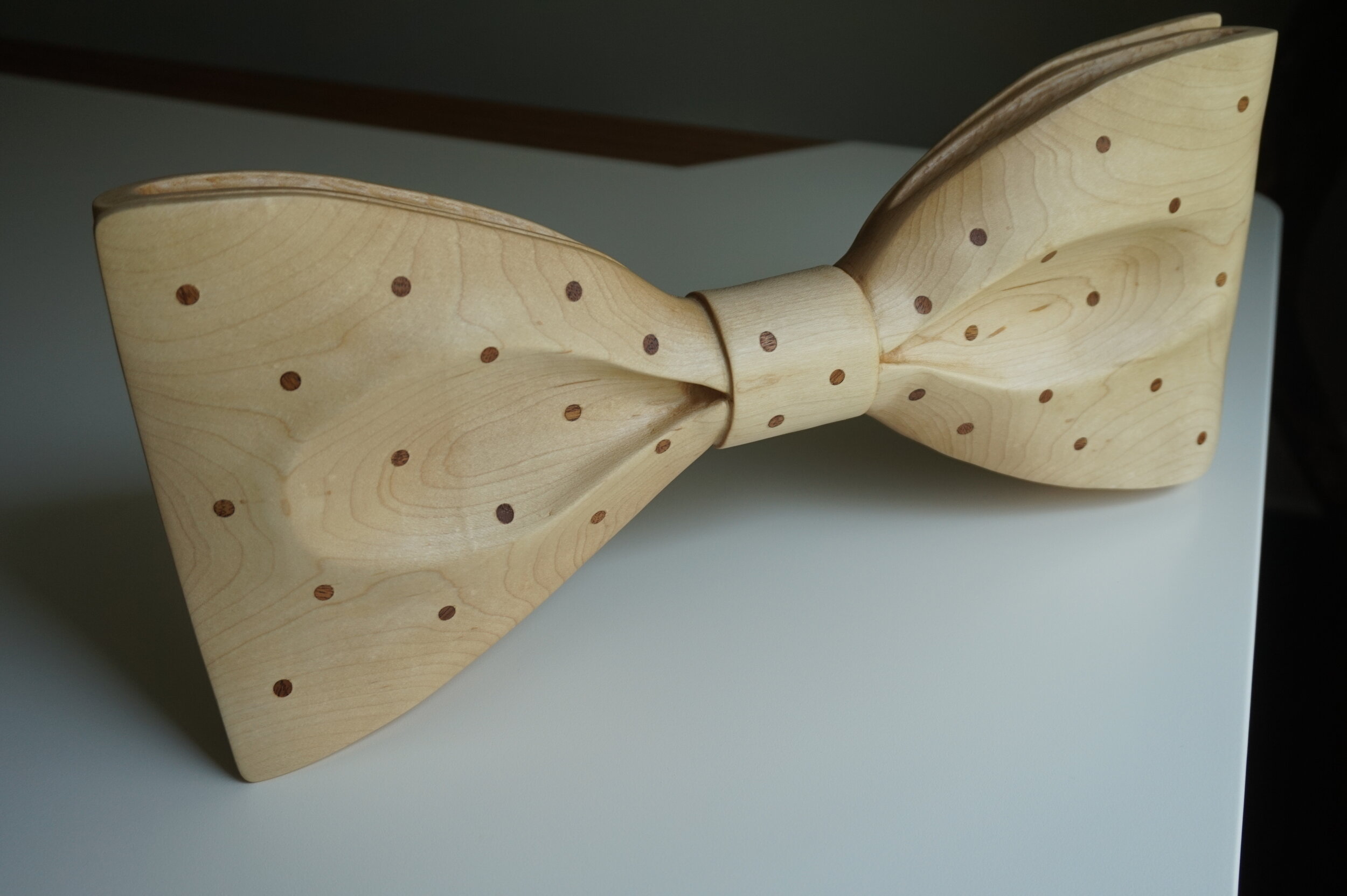  Maple, power and hand, carved bowtie with mahogany inlaid polka dots. 