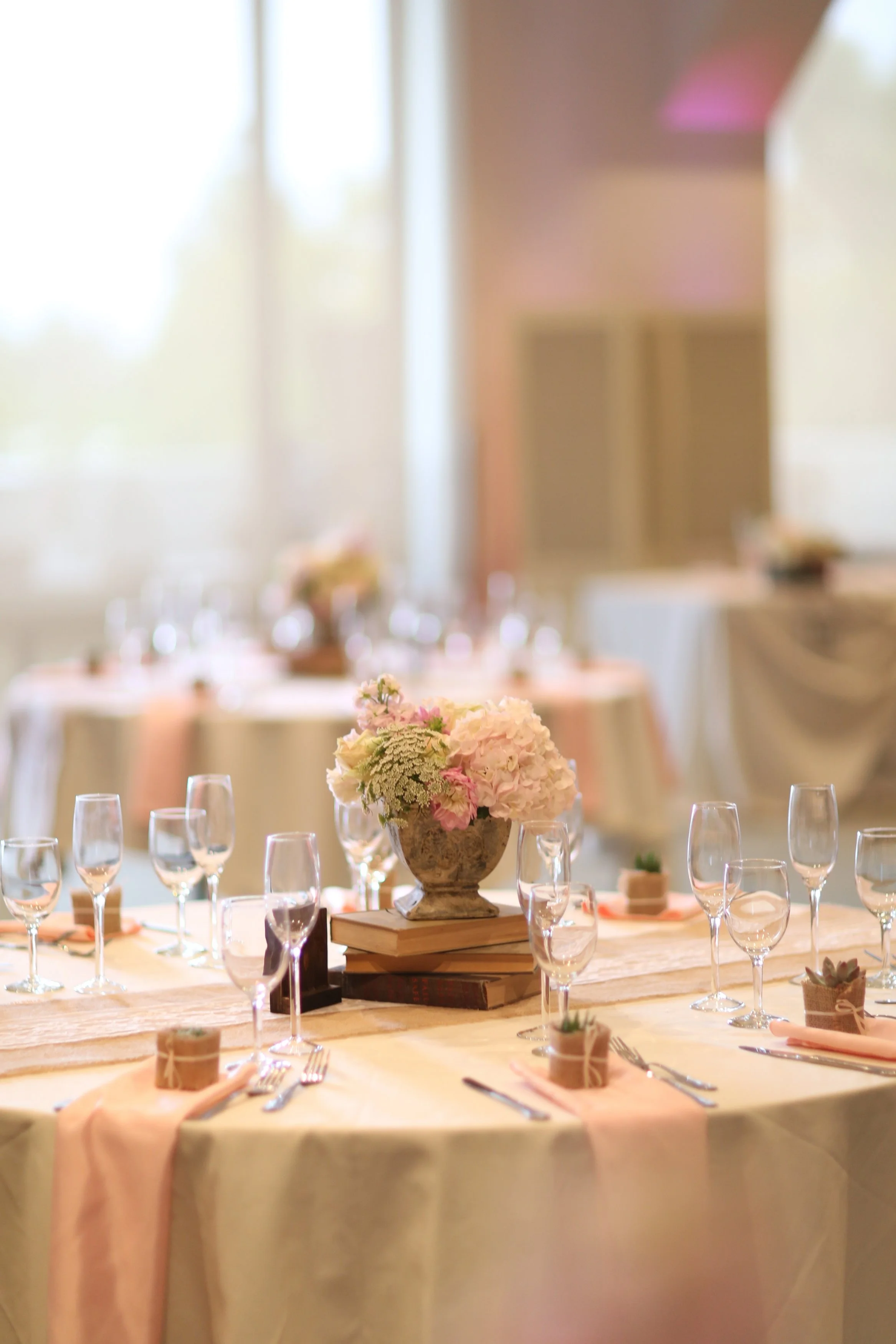 Ali wanted simple flowers with old vintage books as centerpieces. Each guests got a small succulent plant as a wedding favor.