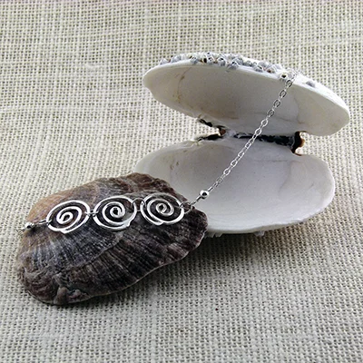 Sterling trio 'heart of the wave' pendant approx 5/8" each with sterling silver chain; 18" length - SOLD