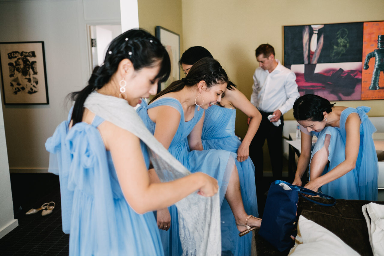  Bridesmaids in blue dresses put on gold sandals 