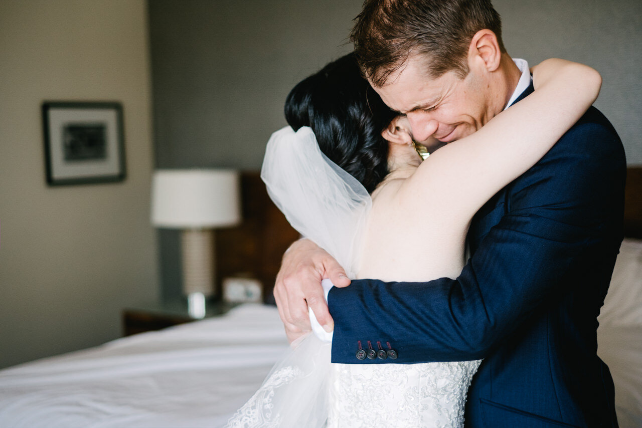  Groom and bride embrace during emotional first look moment 
