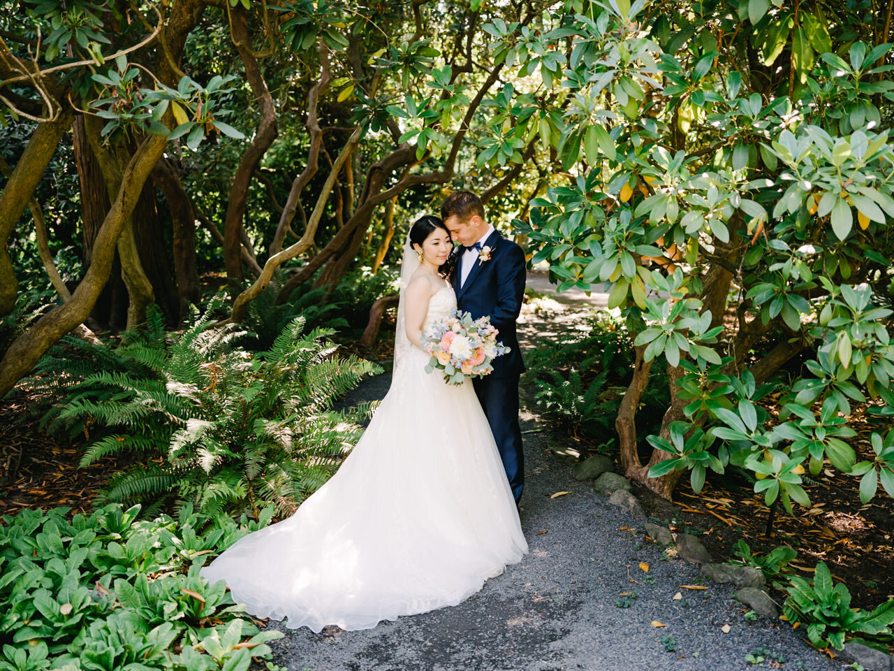  Bride and groom together under rhododendrons and giant fern at crystal springs 