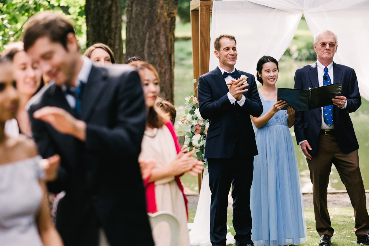  Groom and guests clap while bride enters ceremony at crystal springs 