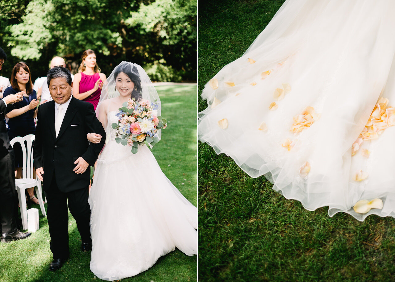  Bride smiles under veil walking with father down aisle at crystal springs wedding 