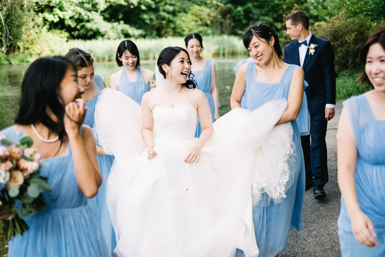  Bride and bridesmaids walking and laughing together 